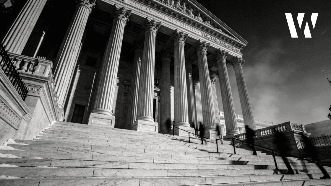 United States Supreme Court building facade and marble columns showing architectural detail in monochrome