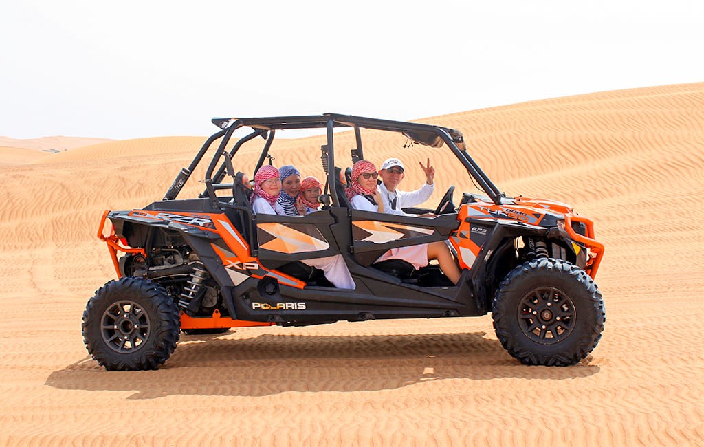 birds flying above white and gray house during daytime