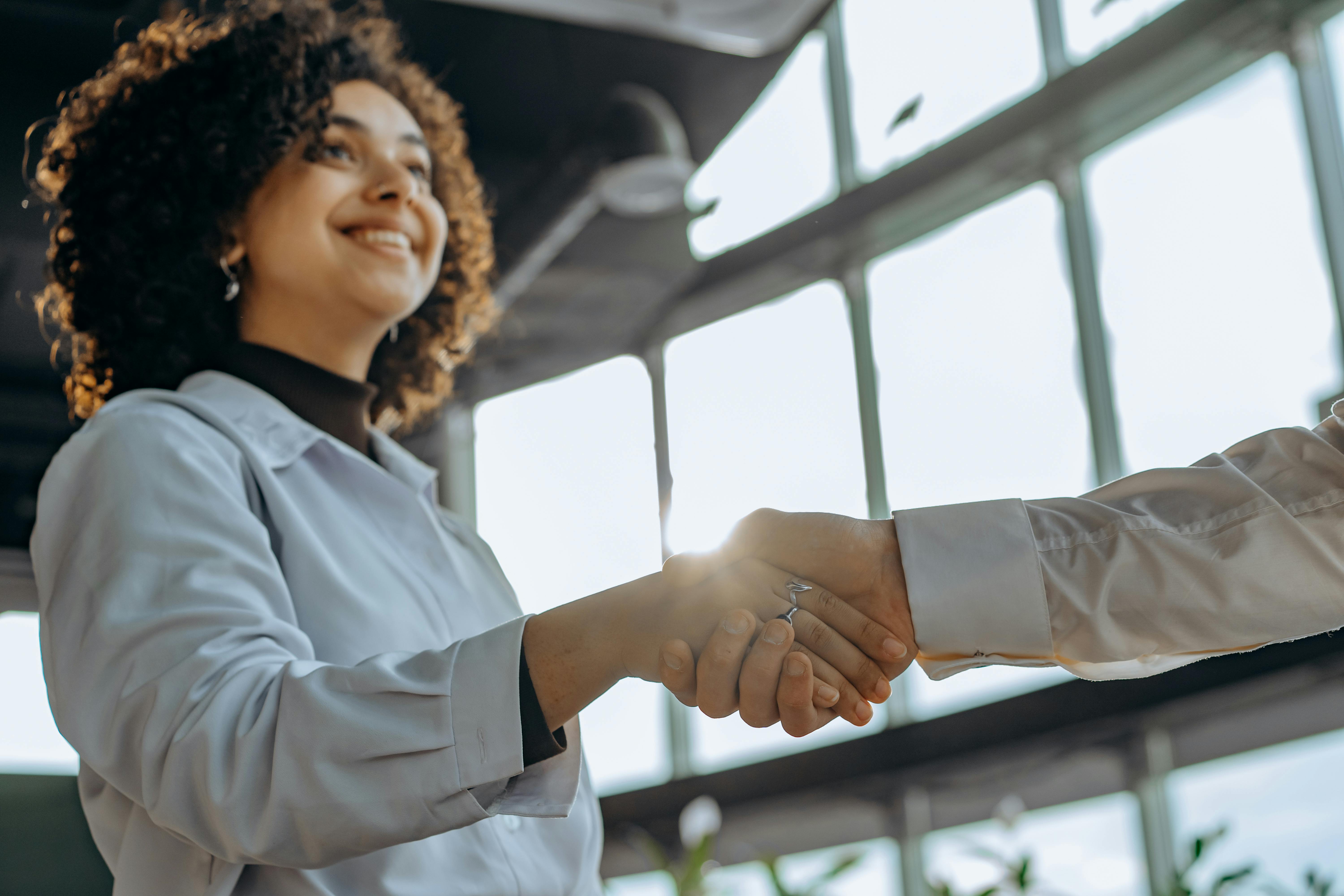 woman holding a phone and man looking at the phone. both are smiling