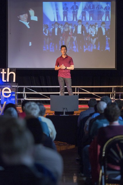 Tony Shriller speaking to an audience in an auditorium