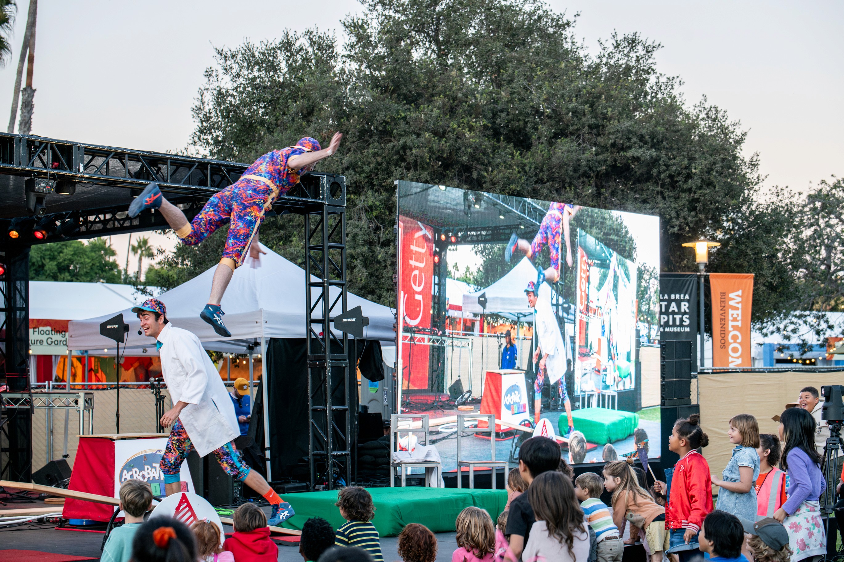 Children gathered around an educational display table at the museum event.