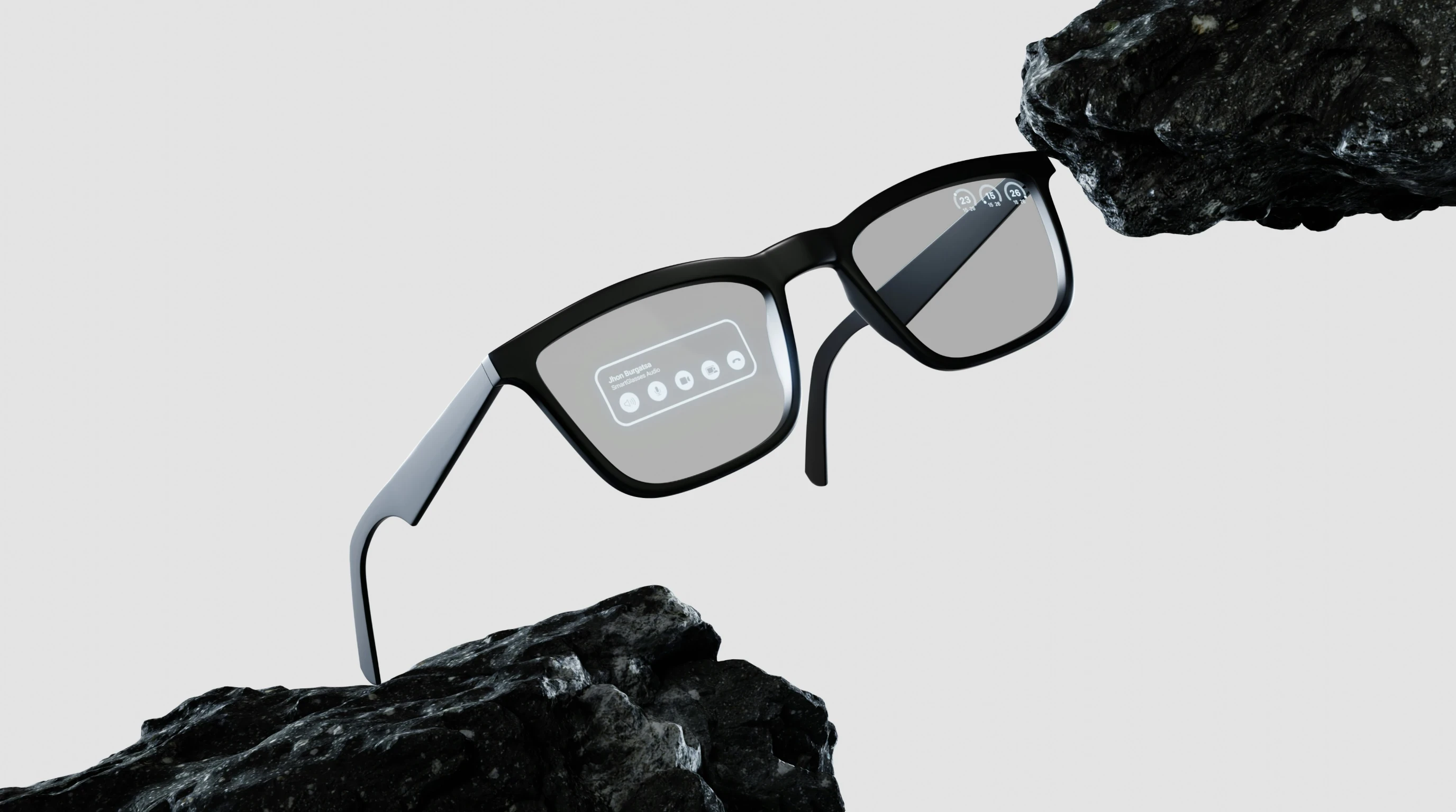 Smart glasses with an in-lens display pictured between two dark rocks.