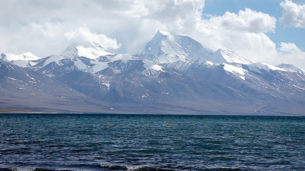 a view of a city and mountains from a distance