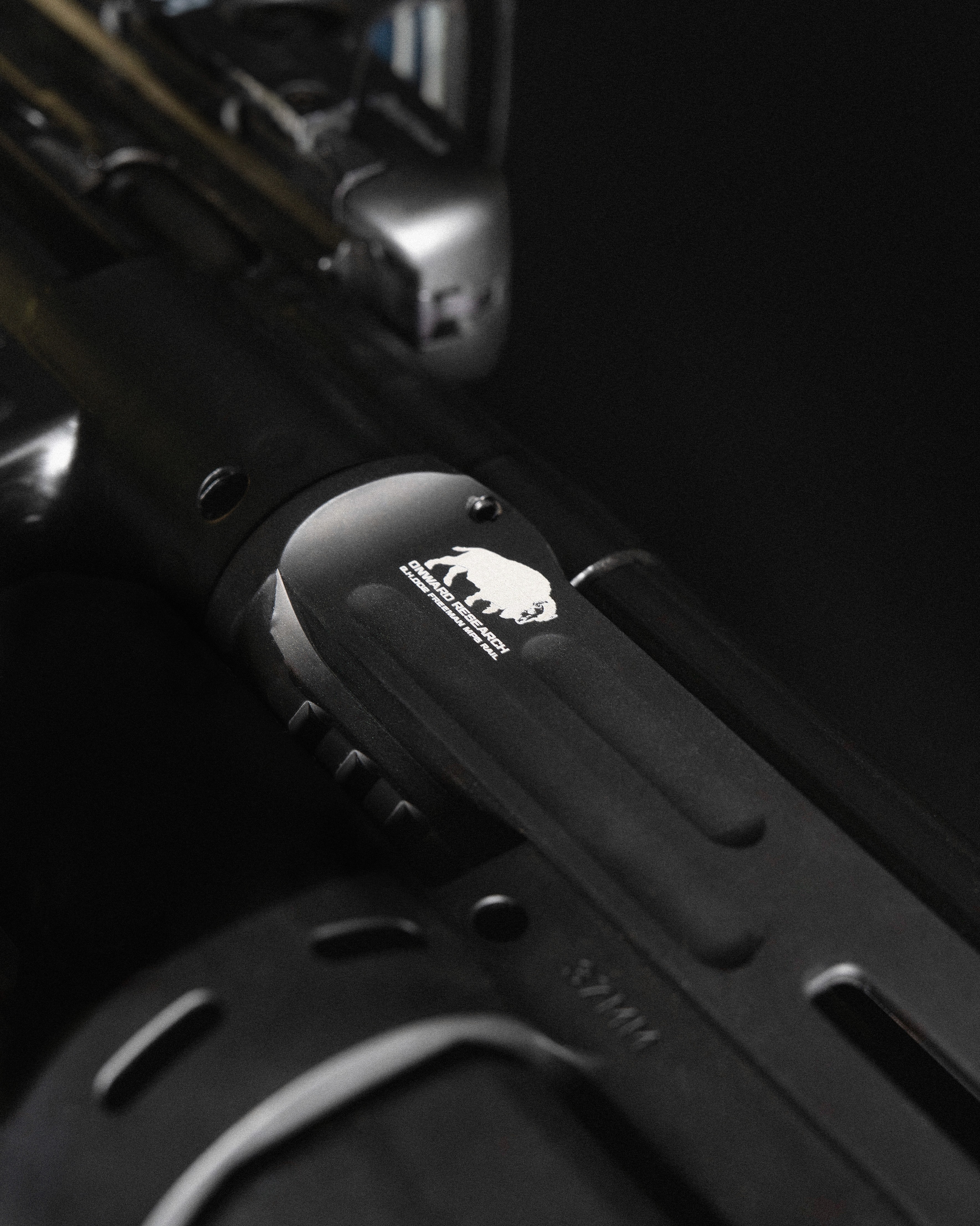 Black and white photo of two people looking at a computer screen with papers on wall