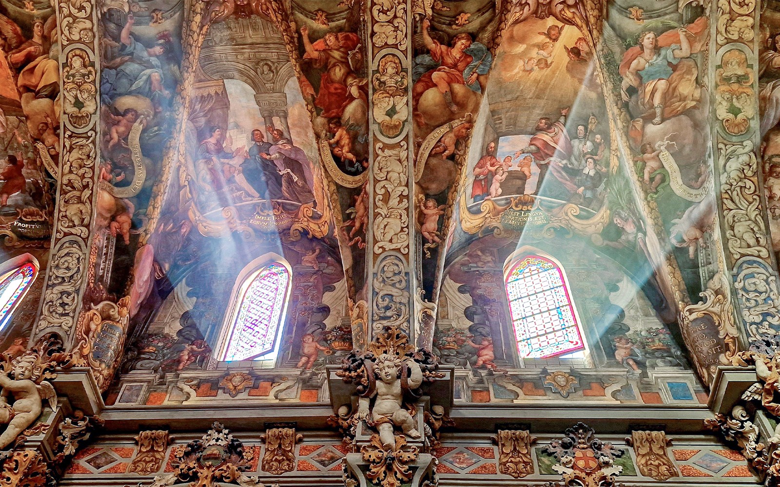 San Nicolas Church ceiling with detailed frescoes and stained glass windows in Valencia, Spain.
