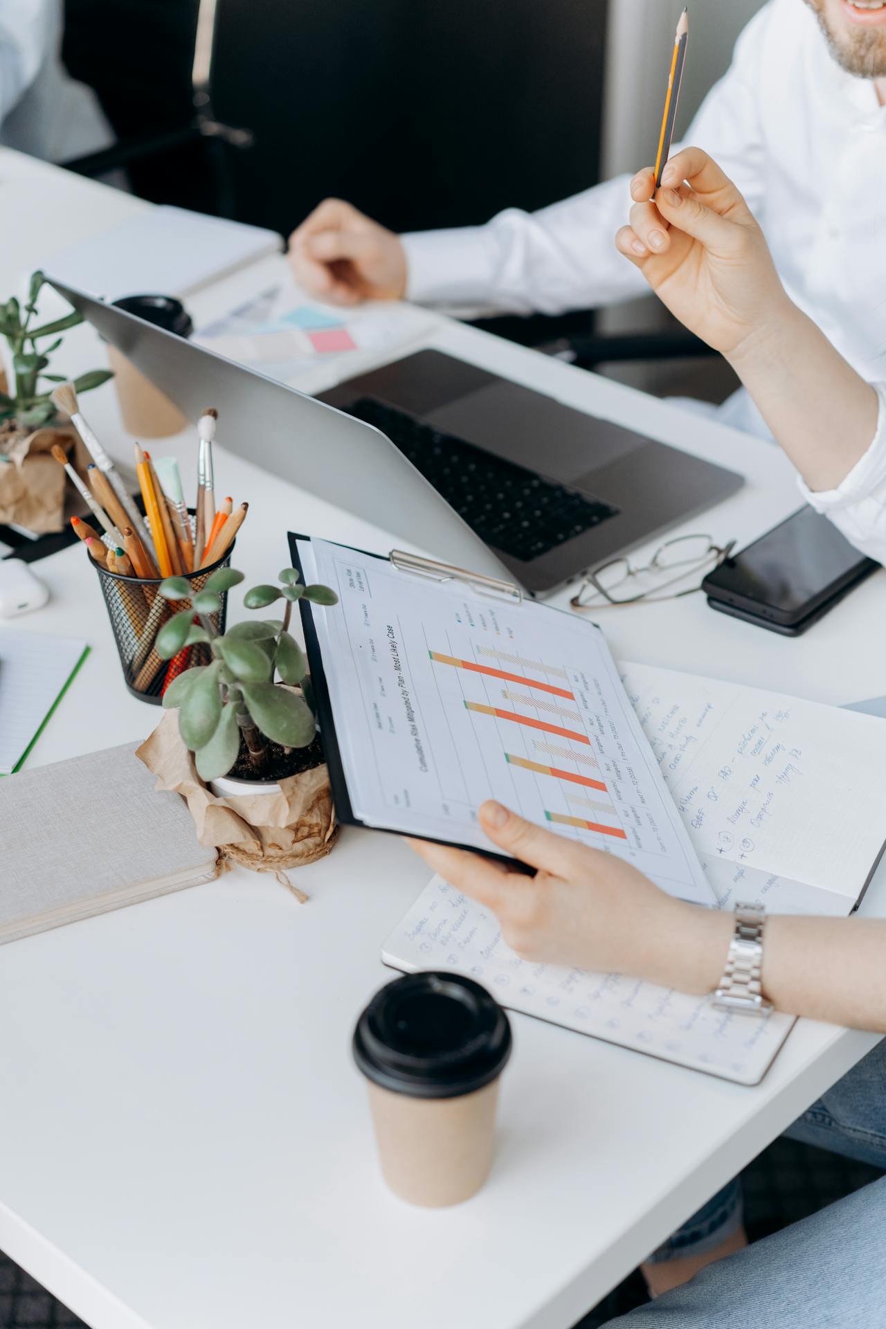 Clipboard checklist beside a laptop—evidence-led baseline control alignment for a Microsoft 365 SME.