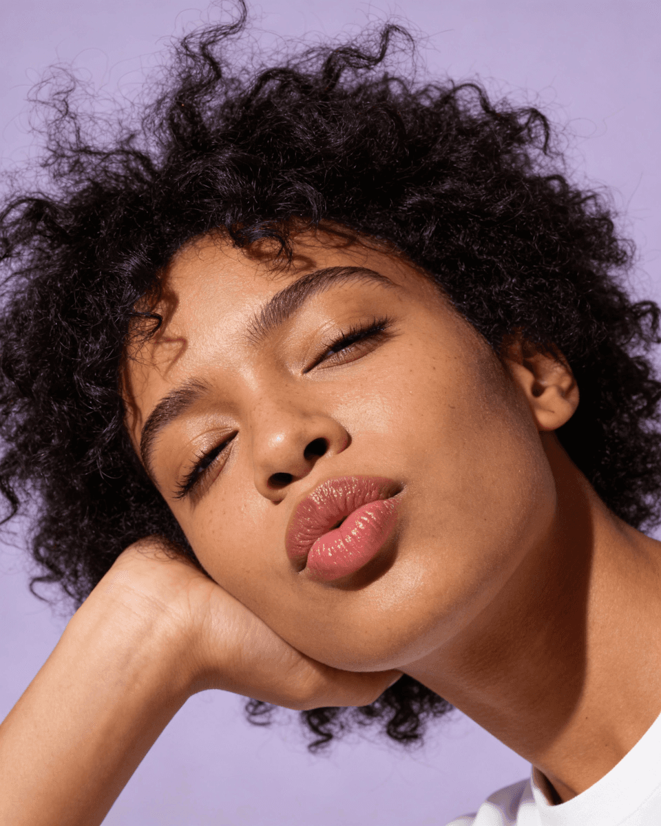 Friends enjoying a sunny outdoor picnic with food.