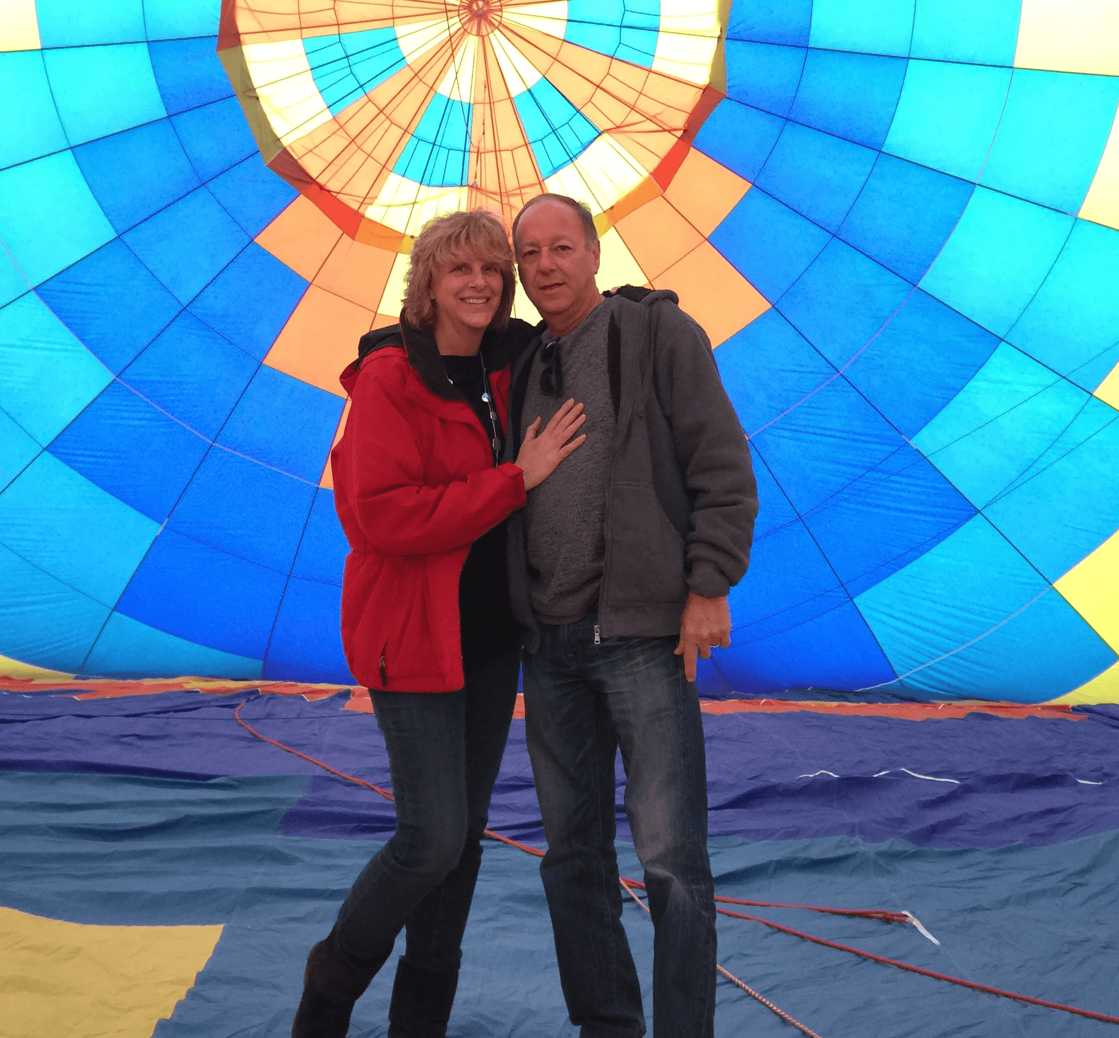 man in blue crew neck t-shirt carrying girl in white and blue stripe dress