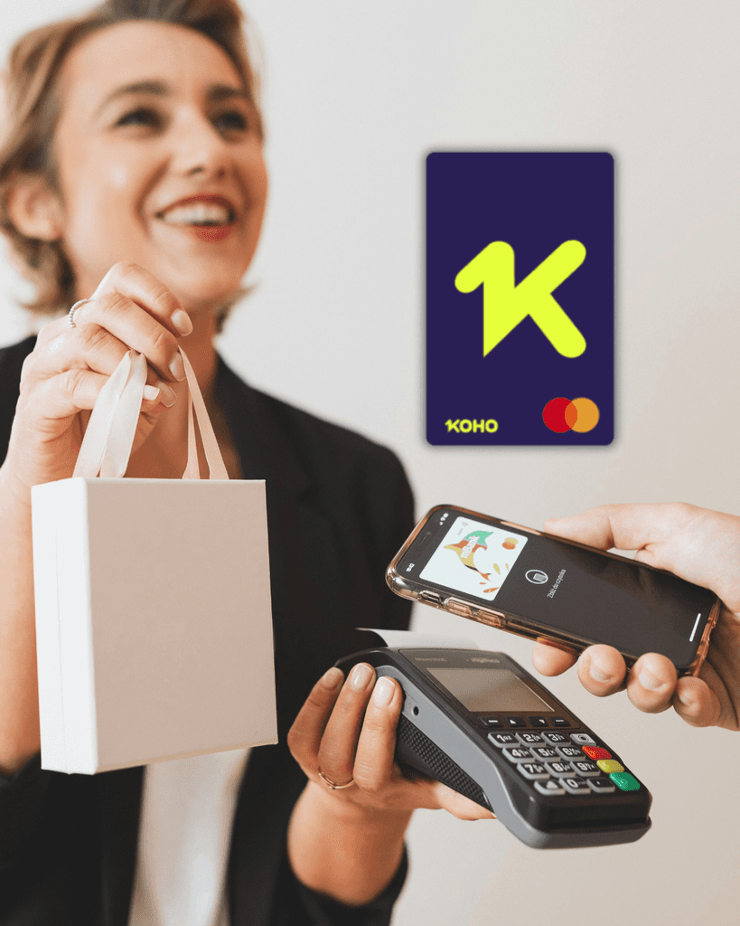 Smiling woman holding a KOHO prepaid Mastercard used to build Canadian credit