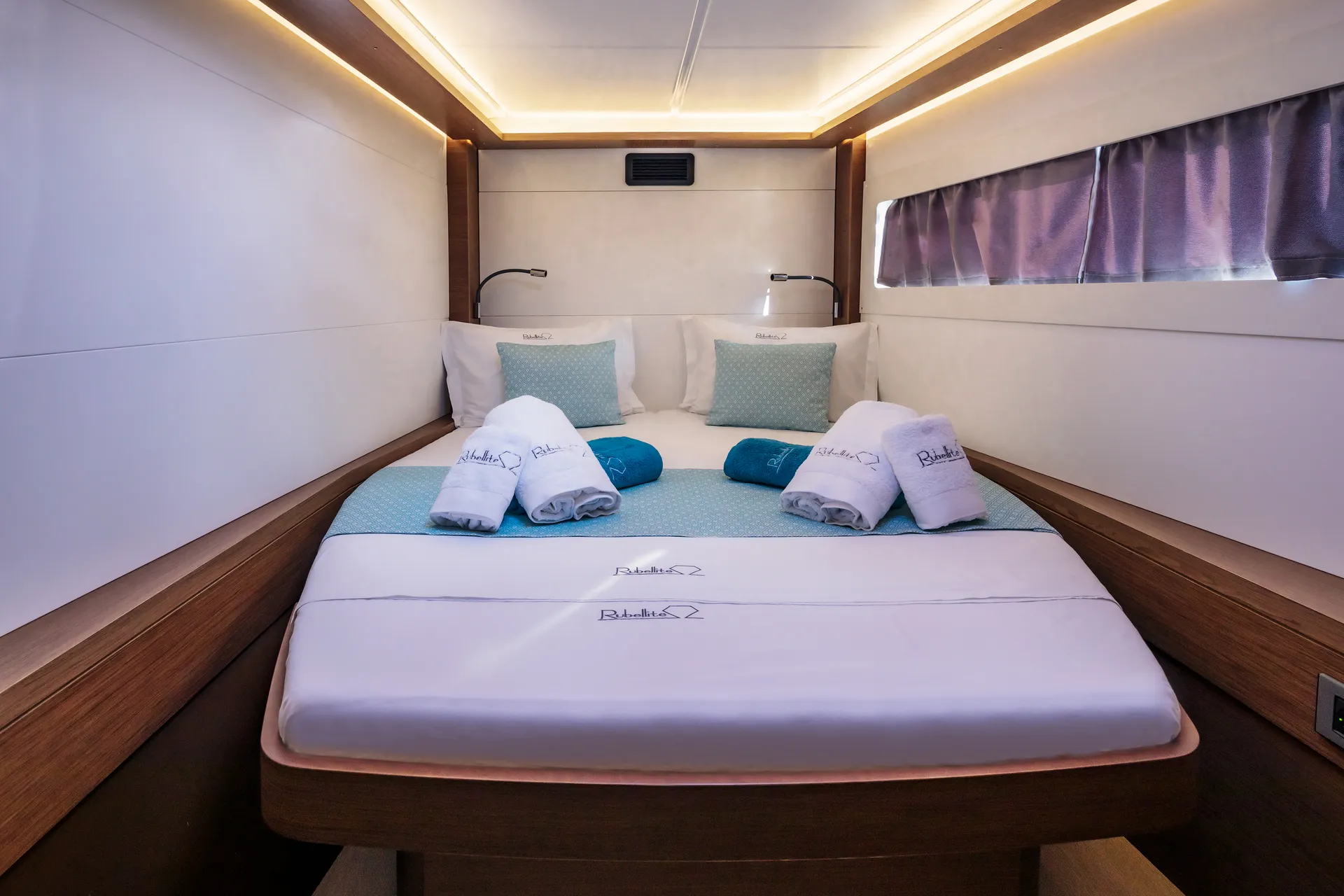 White Rock 36 speedboat with captain at helm cruising calm blue waters near Paros coastline with hills in background.