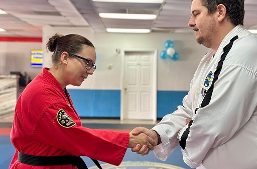 Student shaking hands with an instructor after graduation.