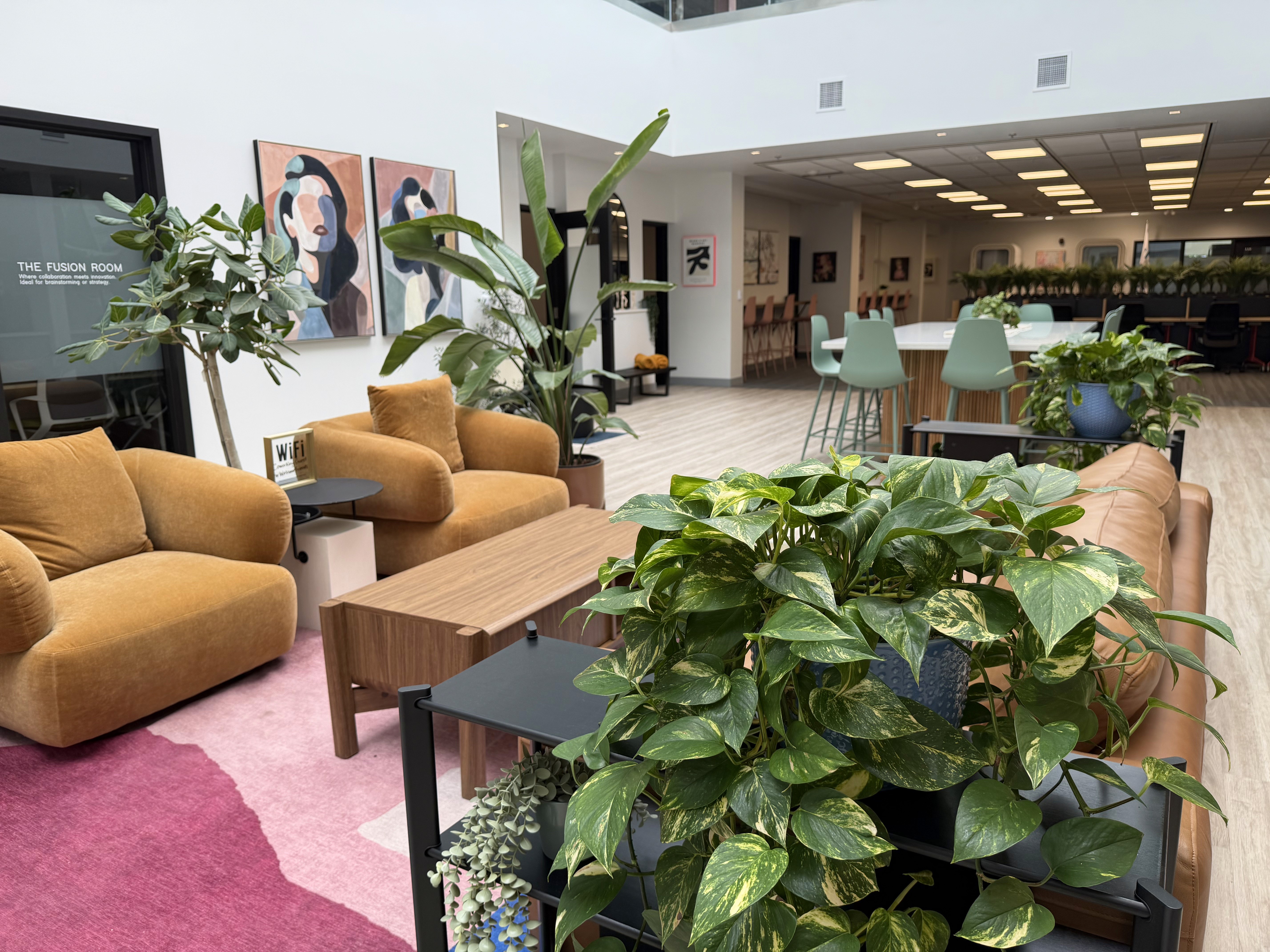 Modern design studio with large windows, work tables, and bold graphic posters displayed on the walls