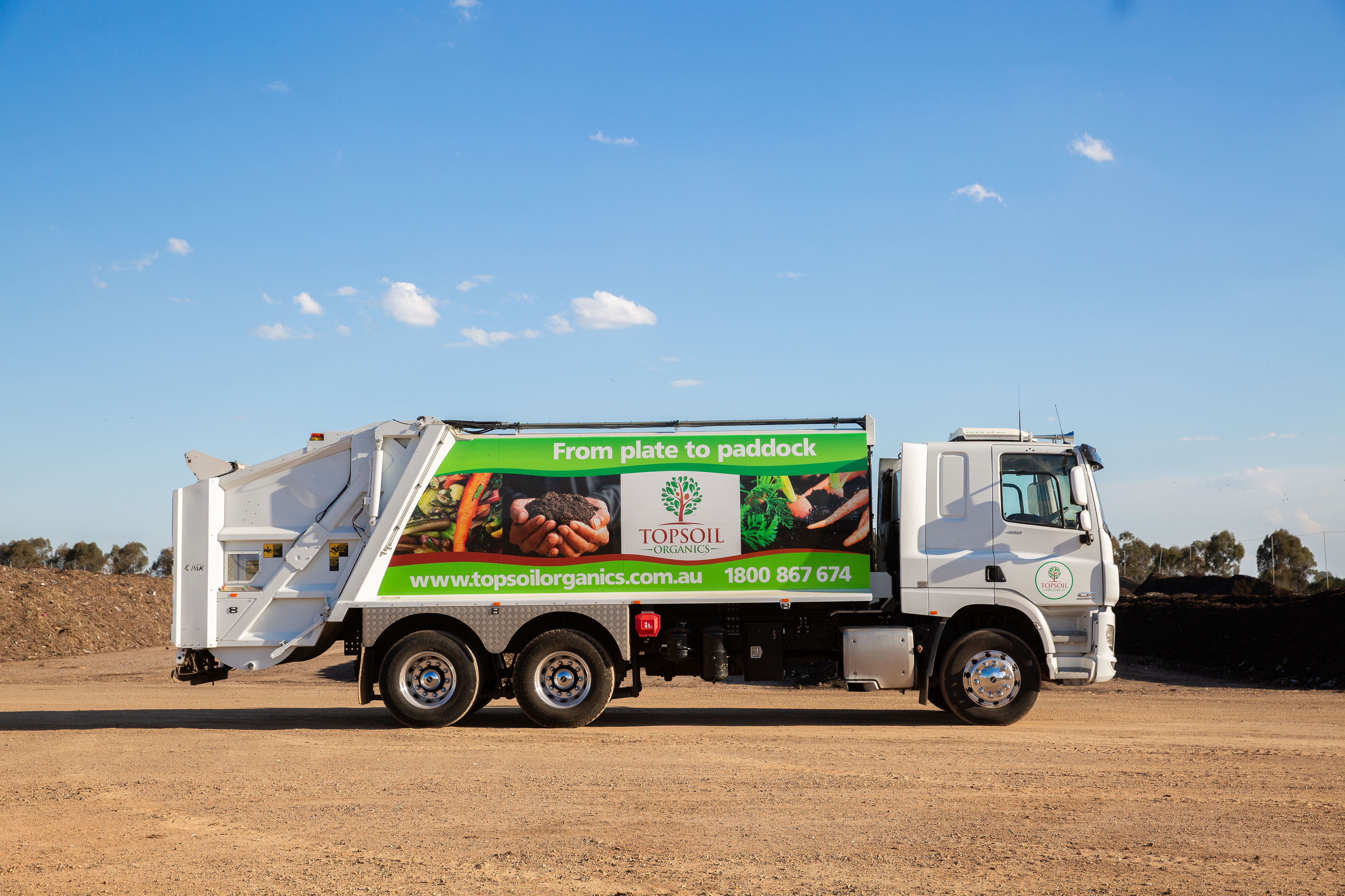 Garbage truck branded with Topsoil Organics graphics and the caption From Plate to Paddock
