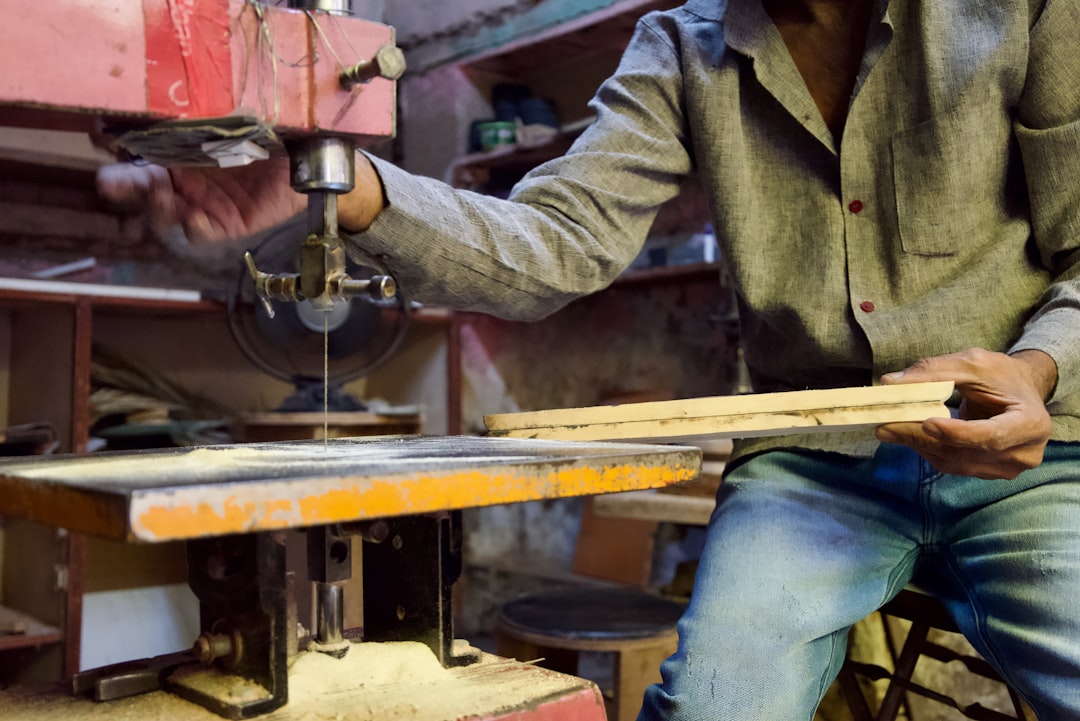 A carpenter is using a saw to cut wood.