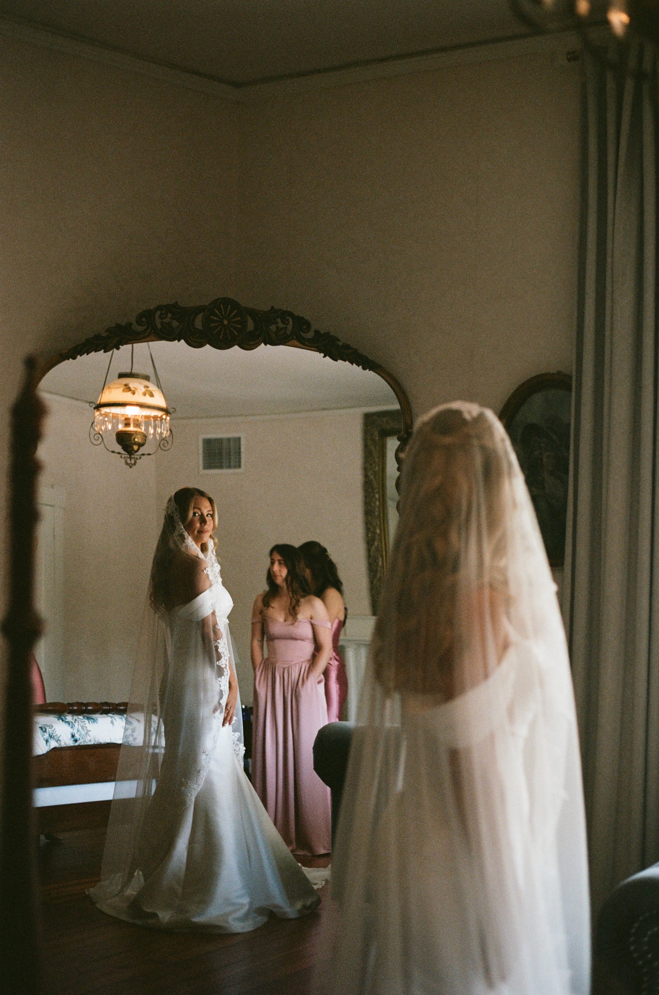     Wedding photographer in South Florida documents a bride getting ready in a mirror reflection before the ceremony om 35mm film.