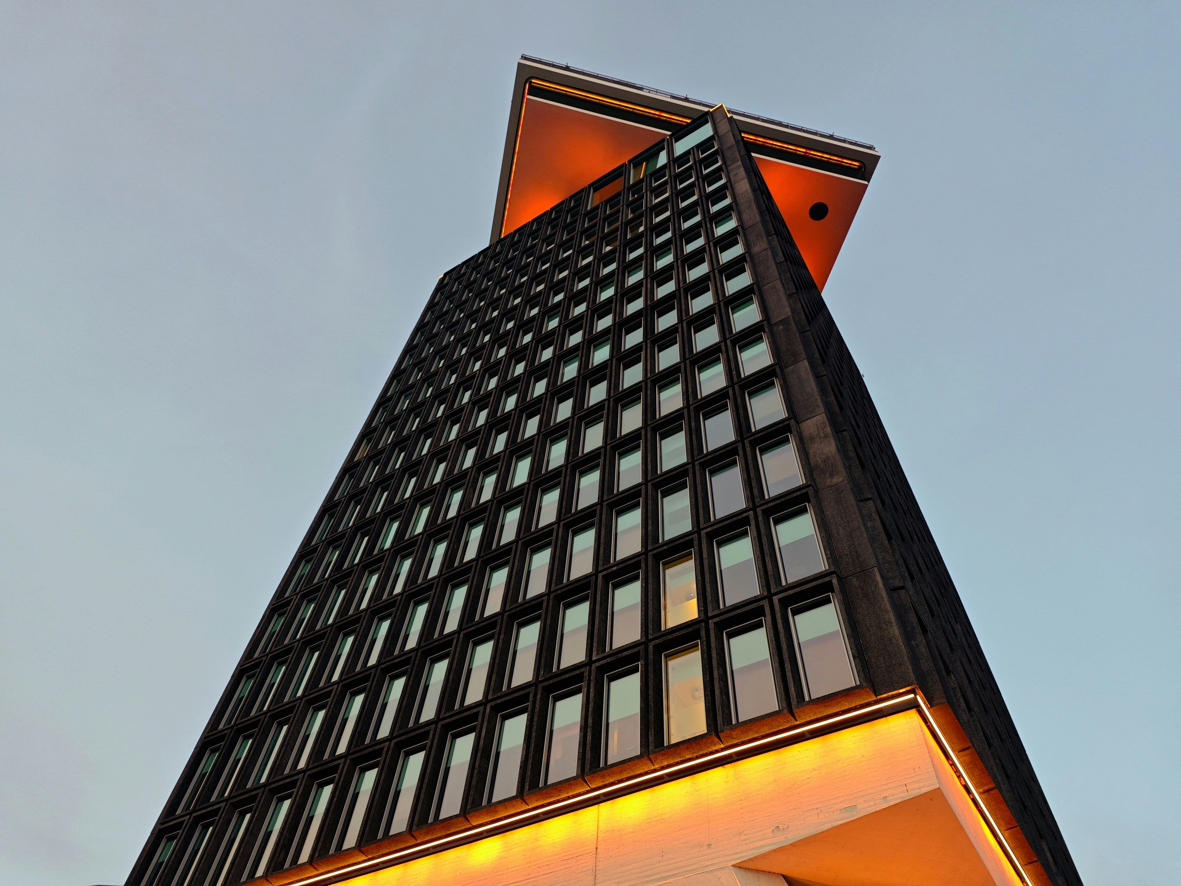 A tall building with unique, illuminated features.
