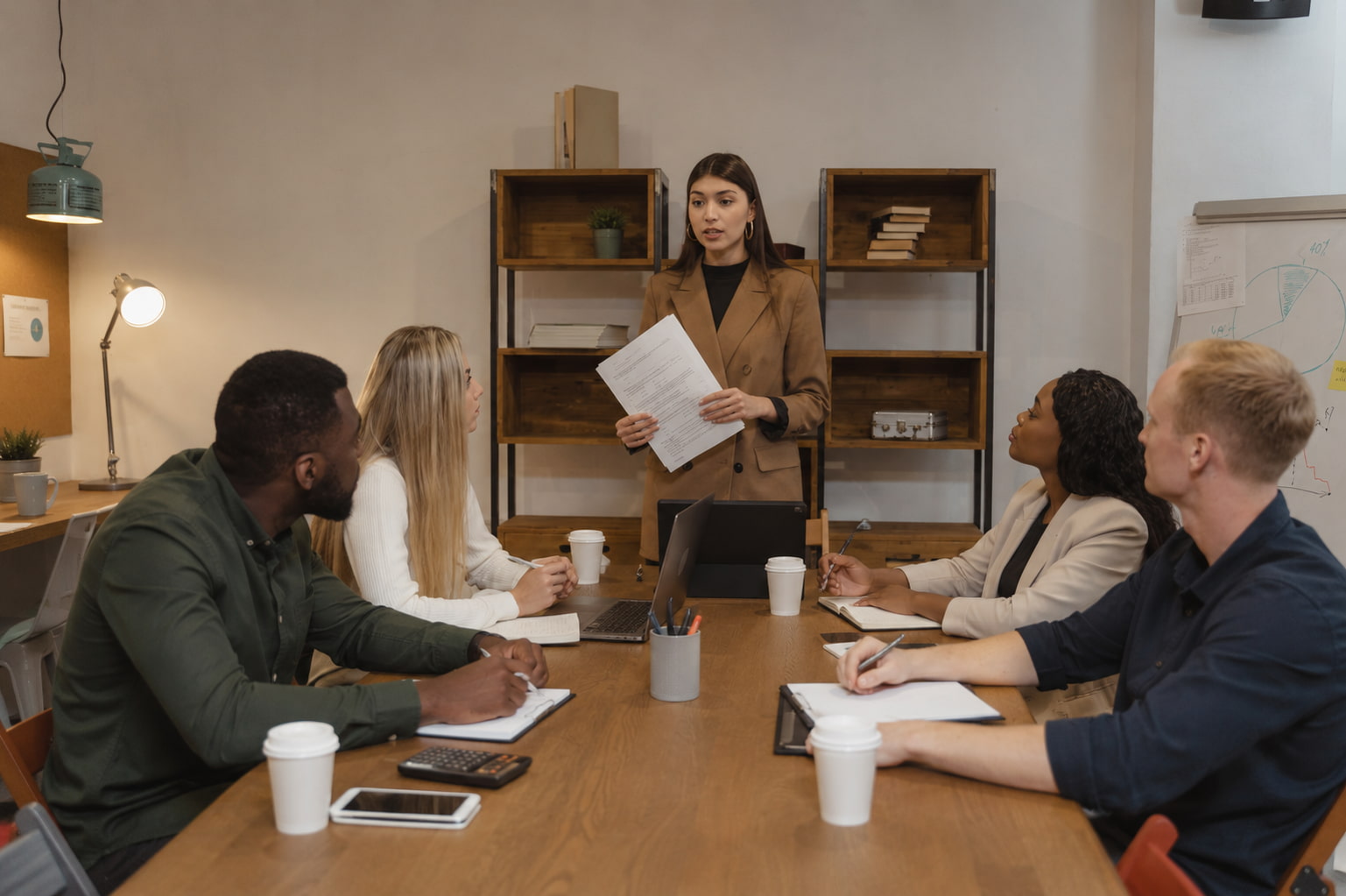 Team meeting showing how to overcome fear through small consistent workplace actions