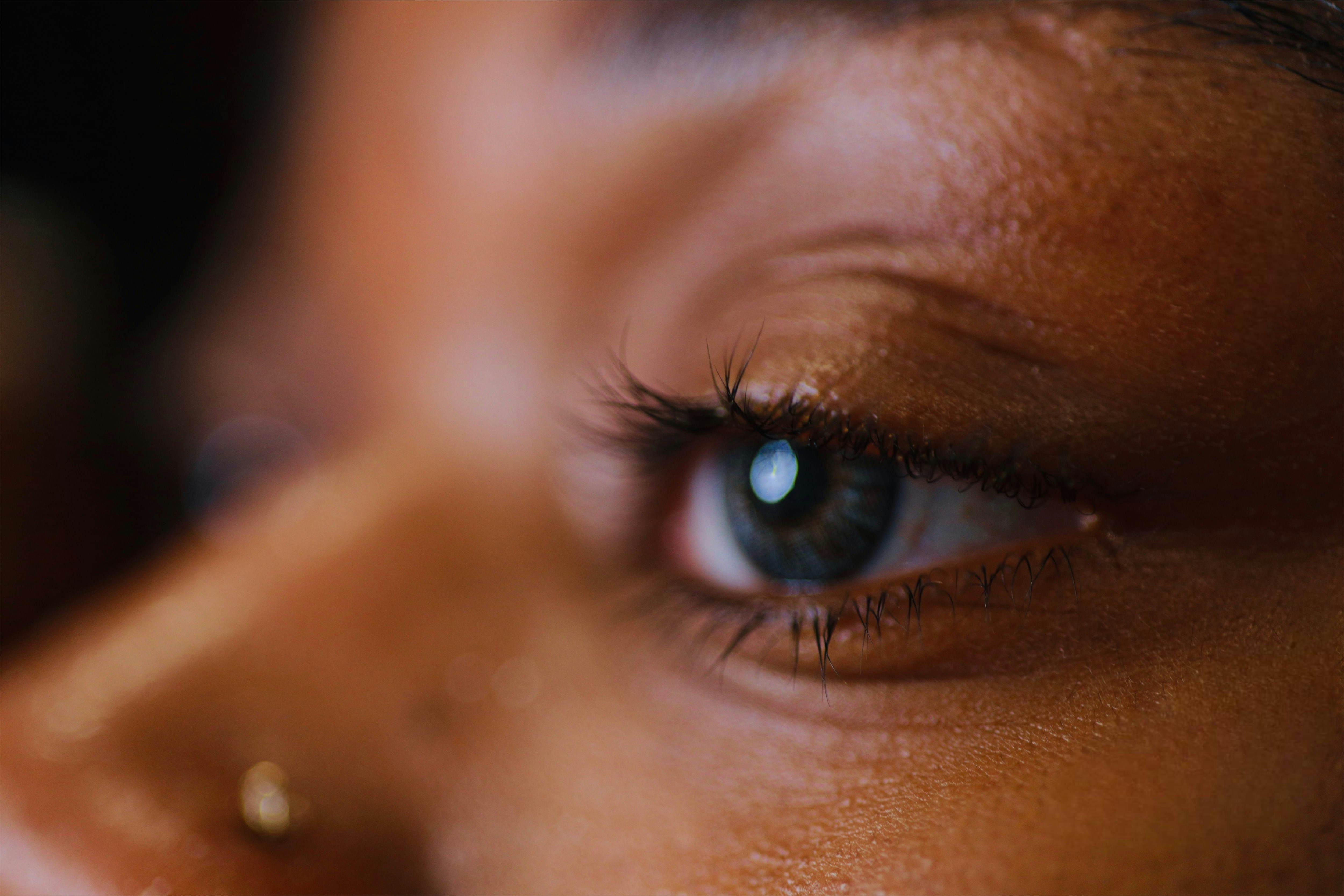 a close up of a woman's blue eye