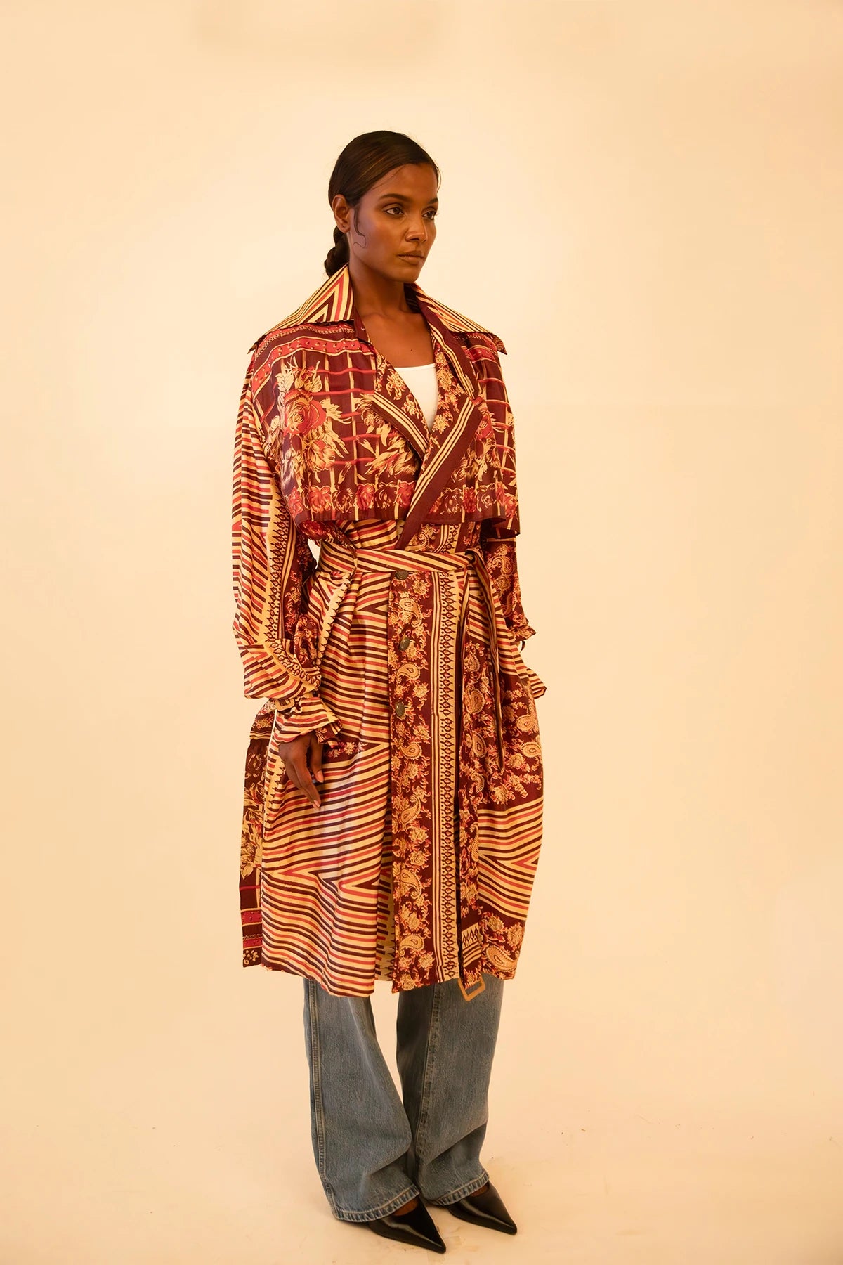 Rust-colored silk trench coat crafted from vintage fabric, featuring a relaxed fit, self-tie belt, and no inner lining, celebrating lightweight layering and conscious design.