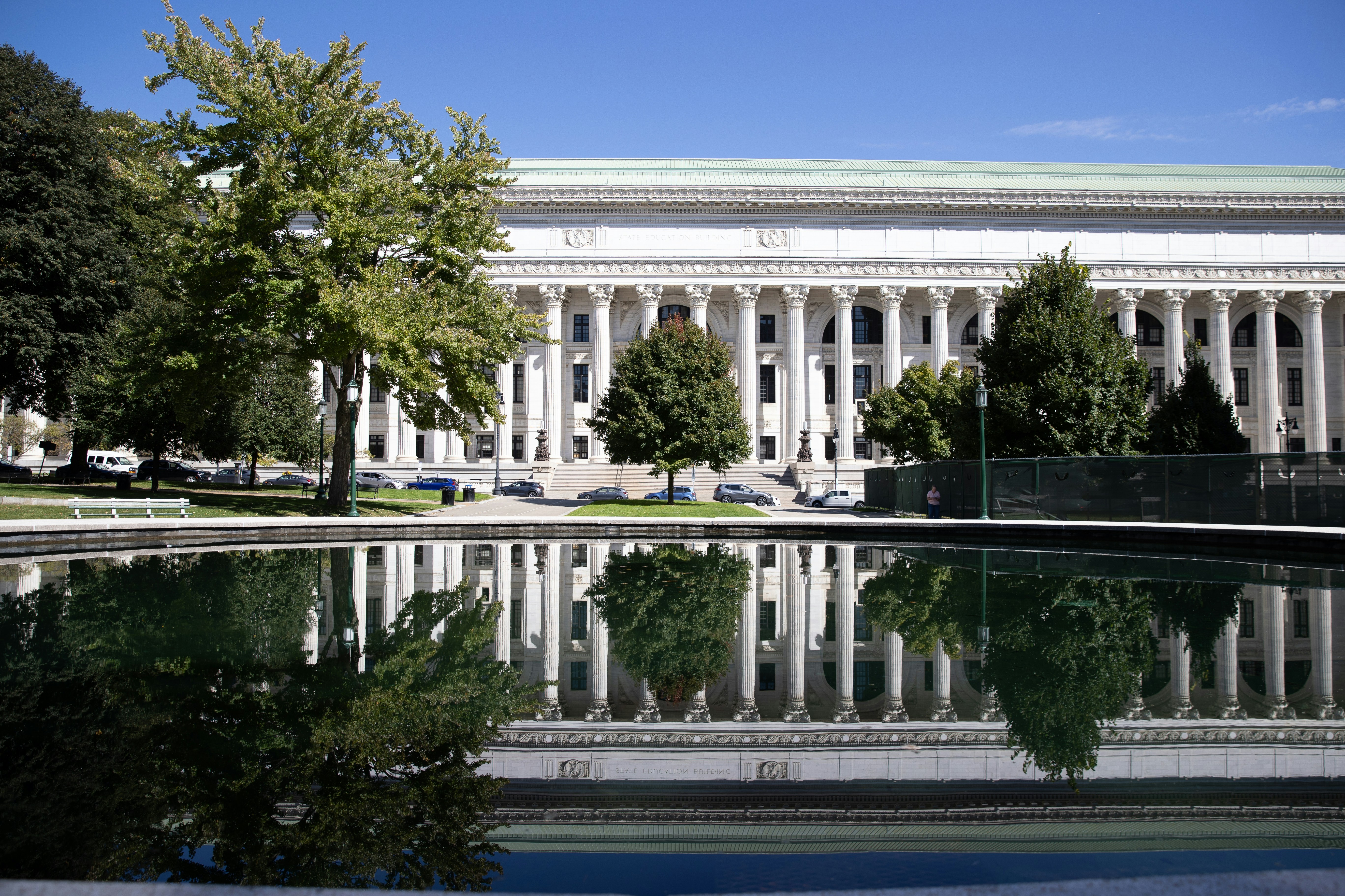 Grand building with columns reflected in water