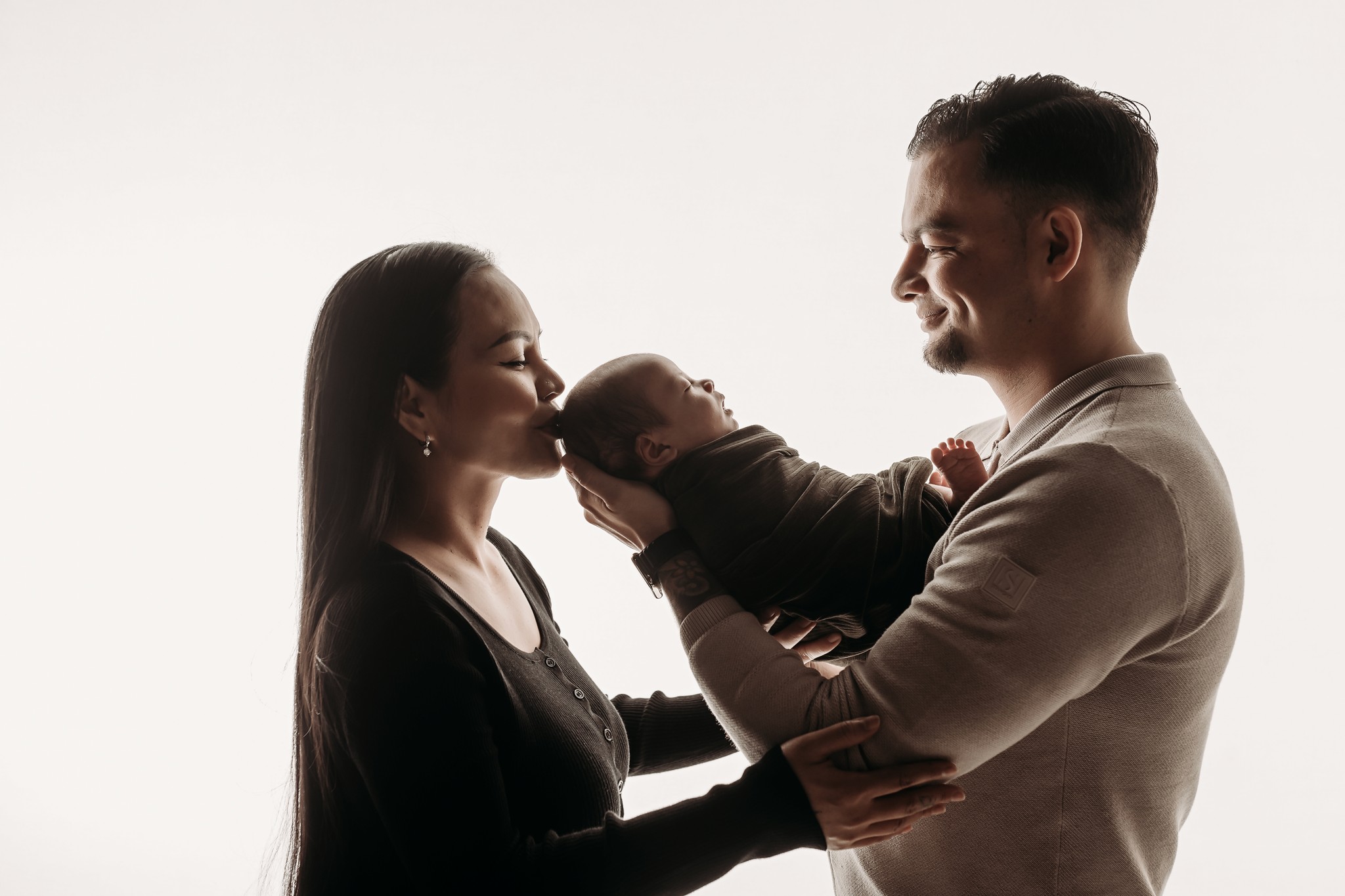 Couple sitting on vintage bicycle in wildflower field at sunset in the Cotswolds