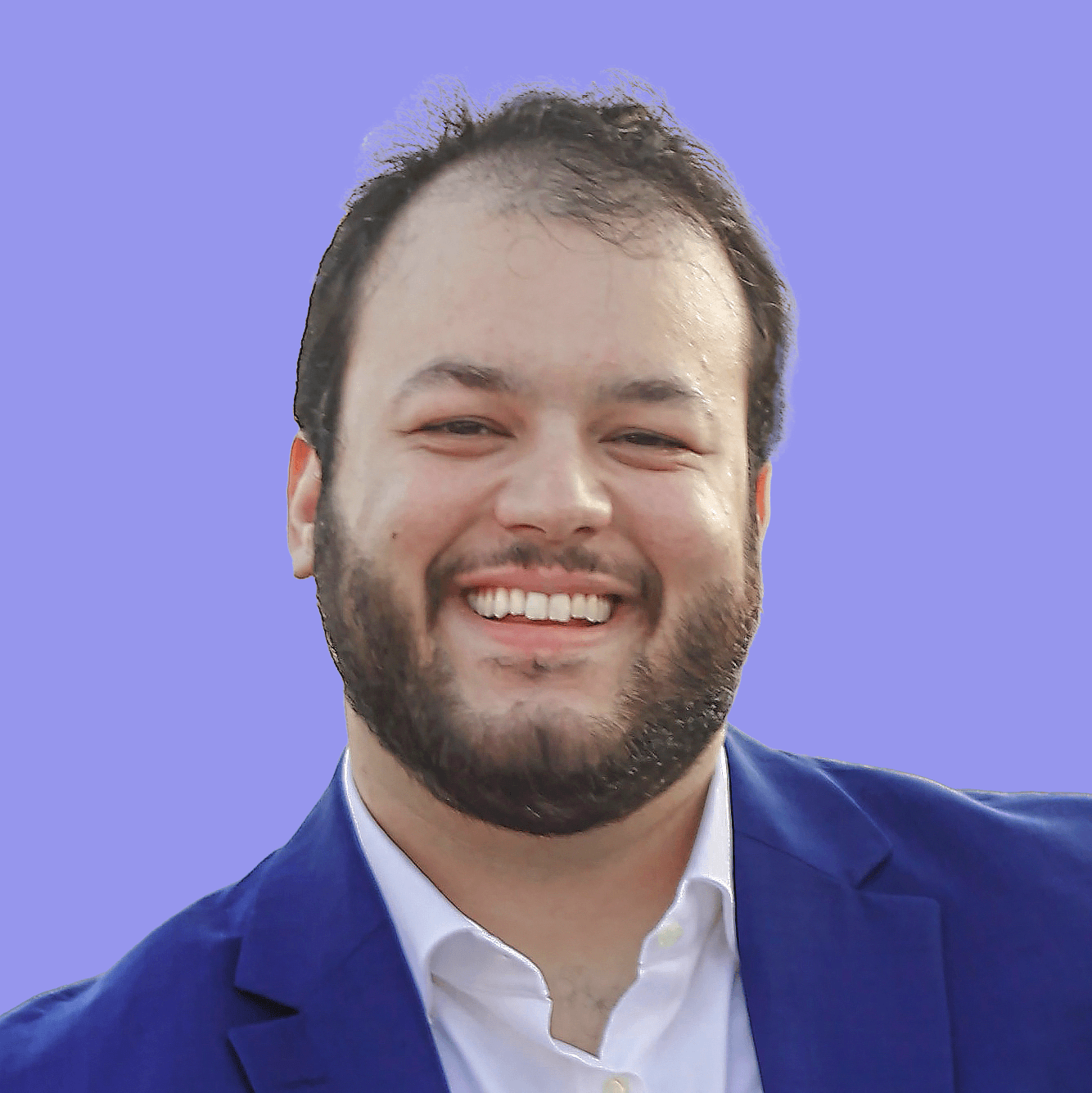 A profile picture showing a white man smiling to the camera, wearing a dark blue suit on top of a white polo t-shirt.
