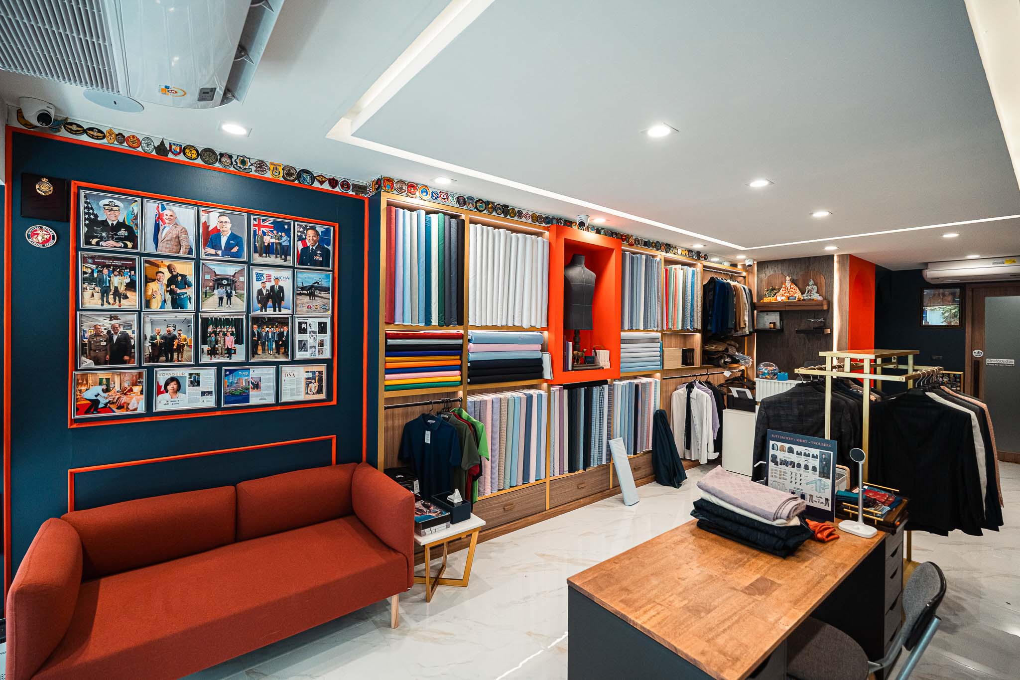 a man standing in front of a rack of clothes