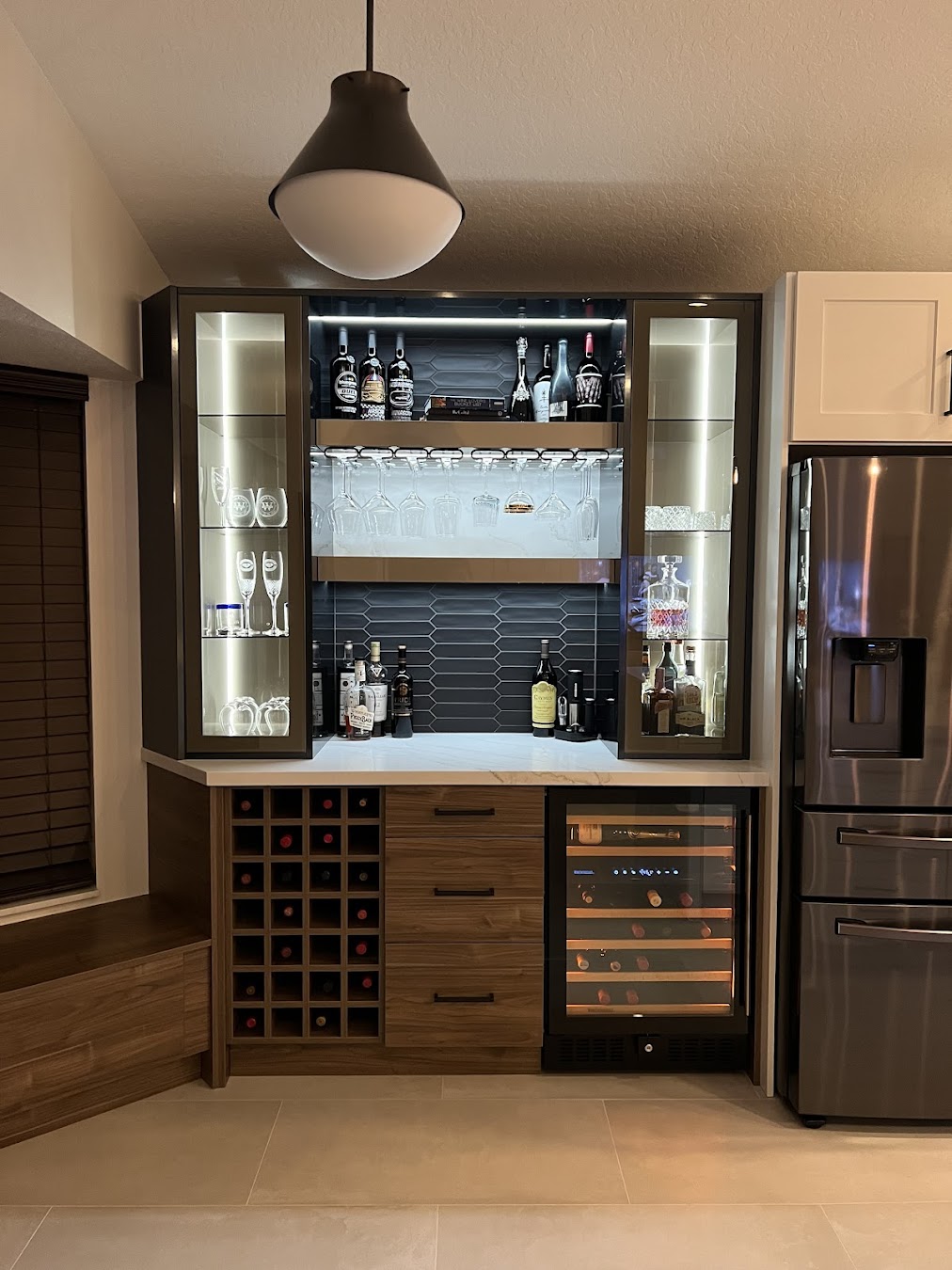 Amazing bar area, with modern Nocce 3 flat doors, glass cabinets, LED, and black tile backsplash,