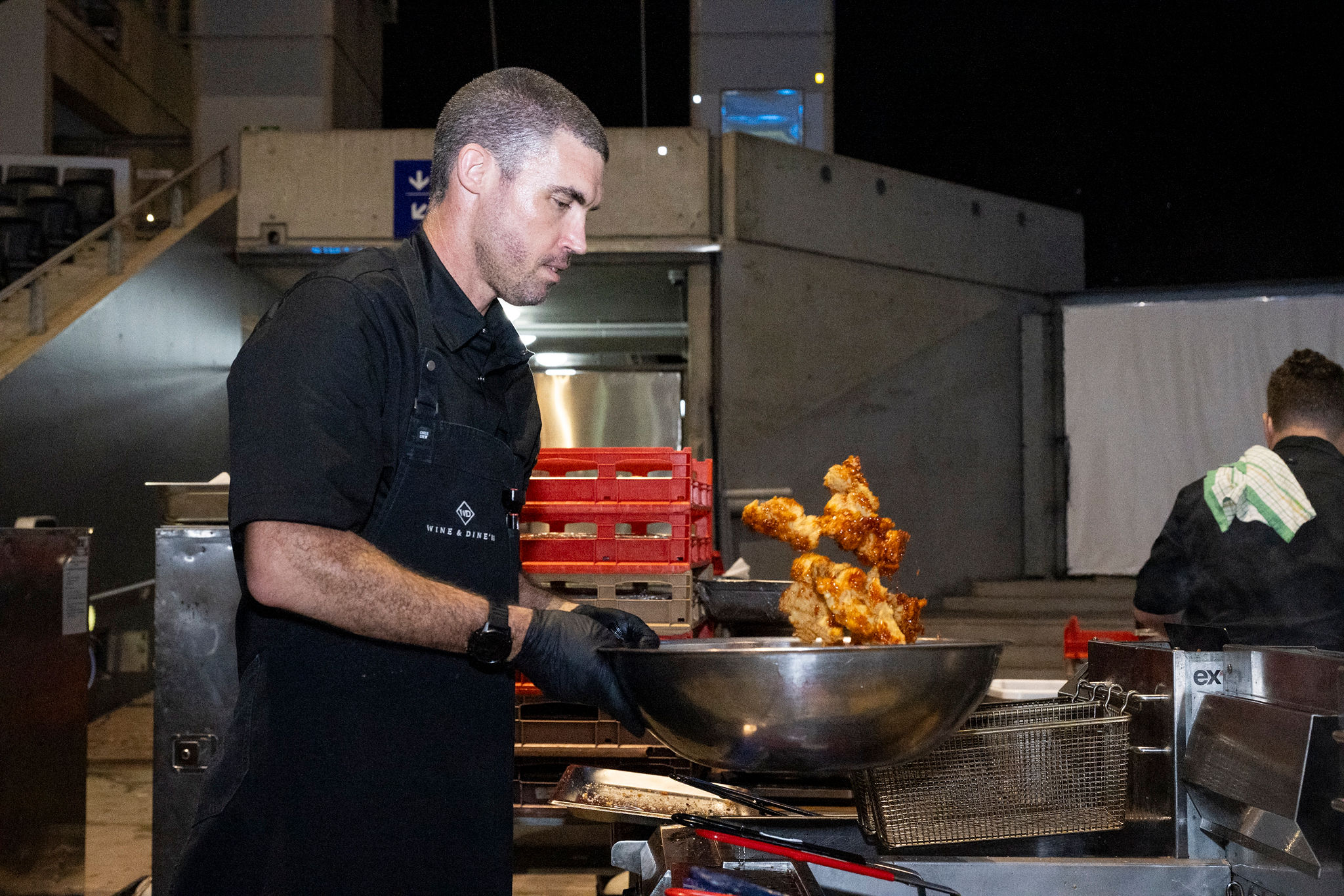 Chef preparing fried chicken in a satelitte kitchen