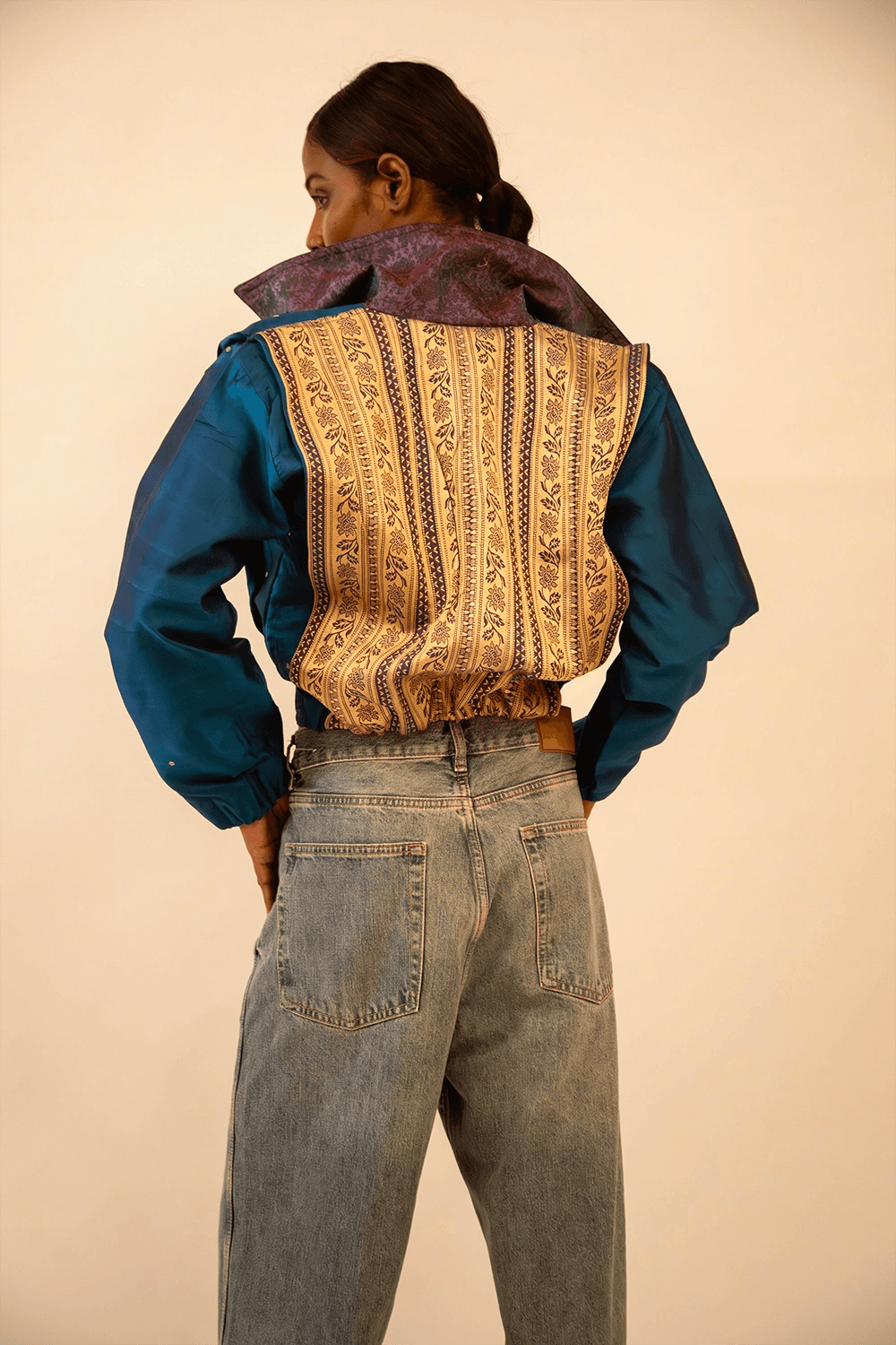AMBR is our one-of-a-kind cropped two-toned silk brocade bomber jacket, handcrafted by skilled artisans in-house using a vintage silk saris