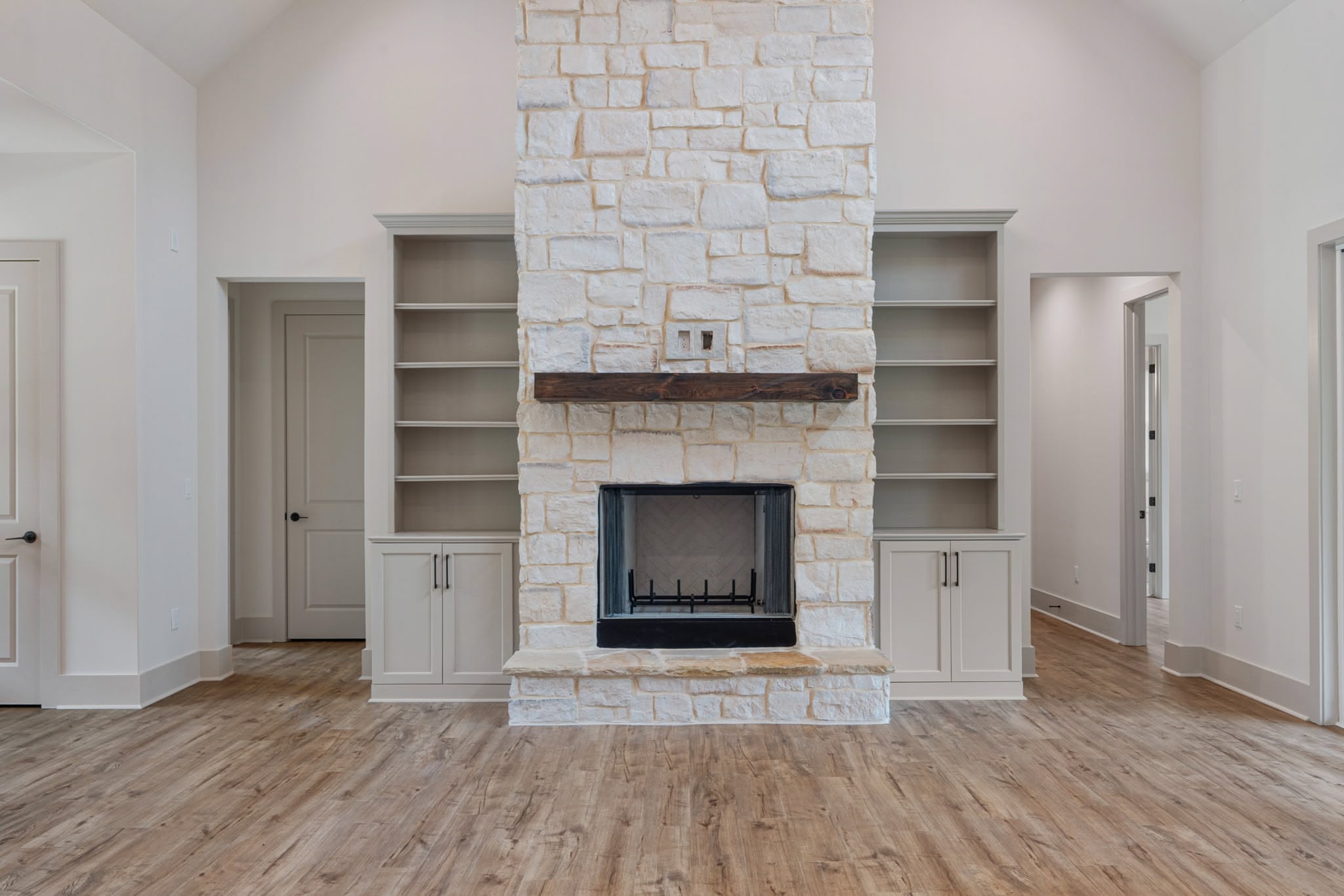 Spacious master bedroom with vaulted ceilings and hardwood floors