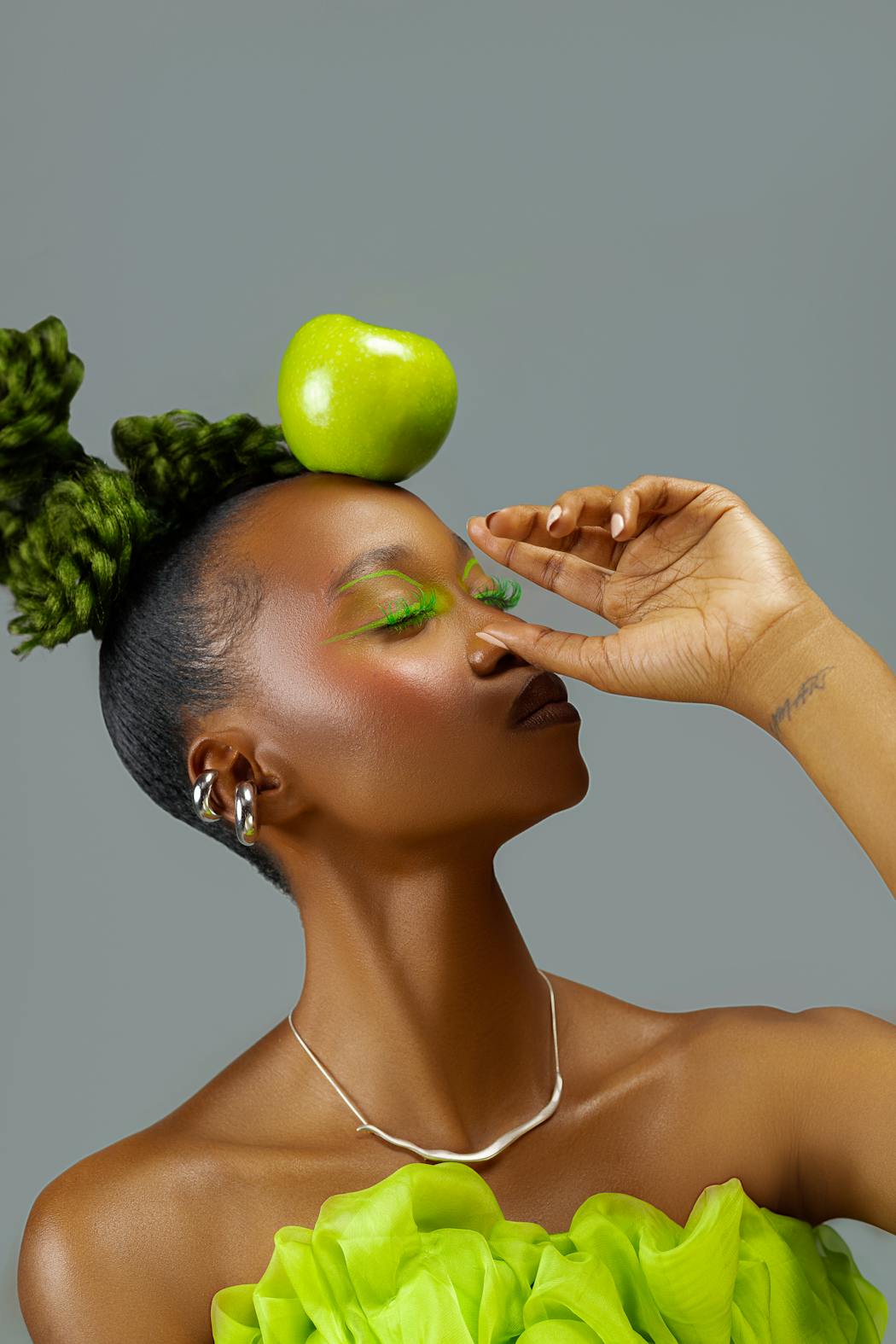 Elegant portrait with green apple and vibrant style