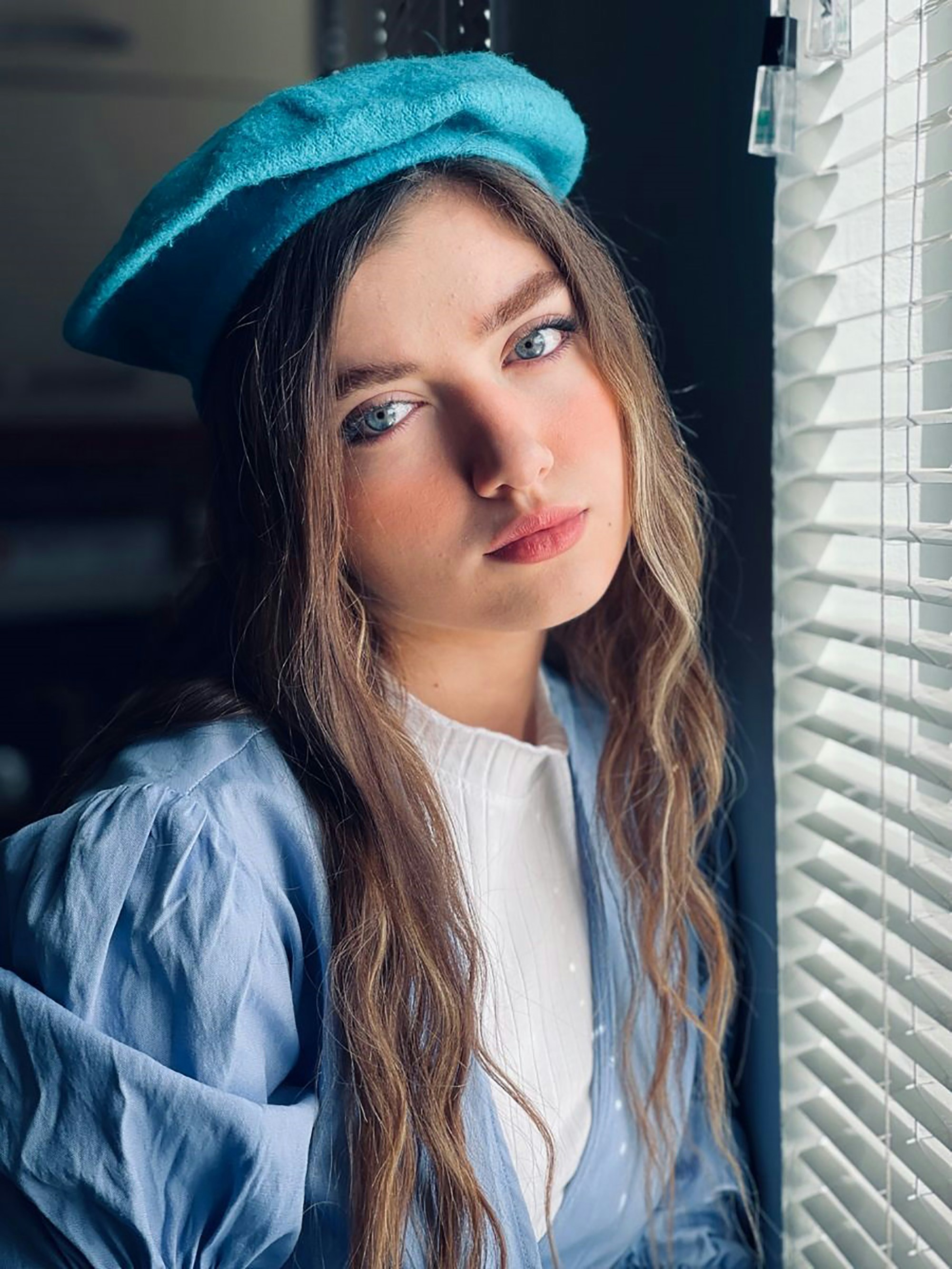 woman in white shirt and blue jacket