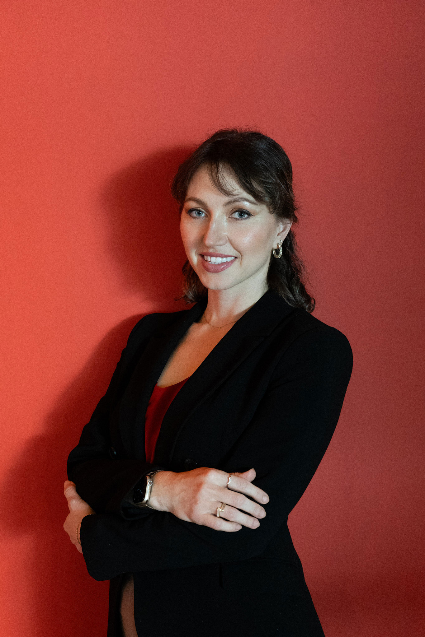 Executive headshot of Elena Hawk, CFP against a red backdrop, studio-style corporate headshots and leadership personal brand portrait.