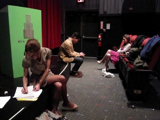 people getting ready for the presentation in the amphitheater
