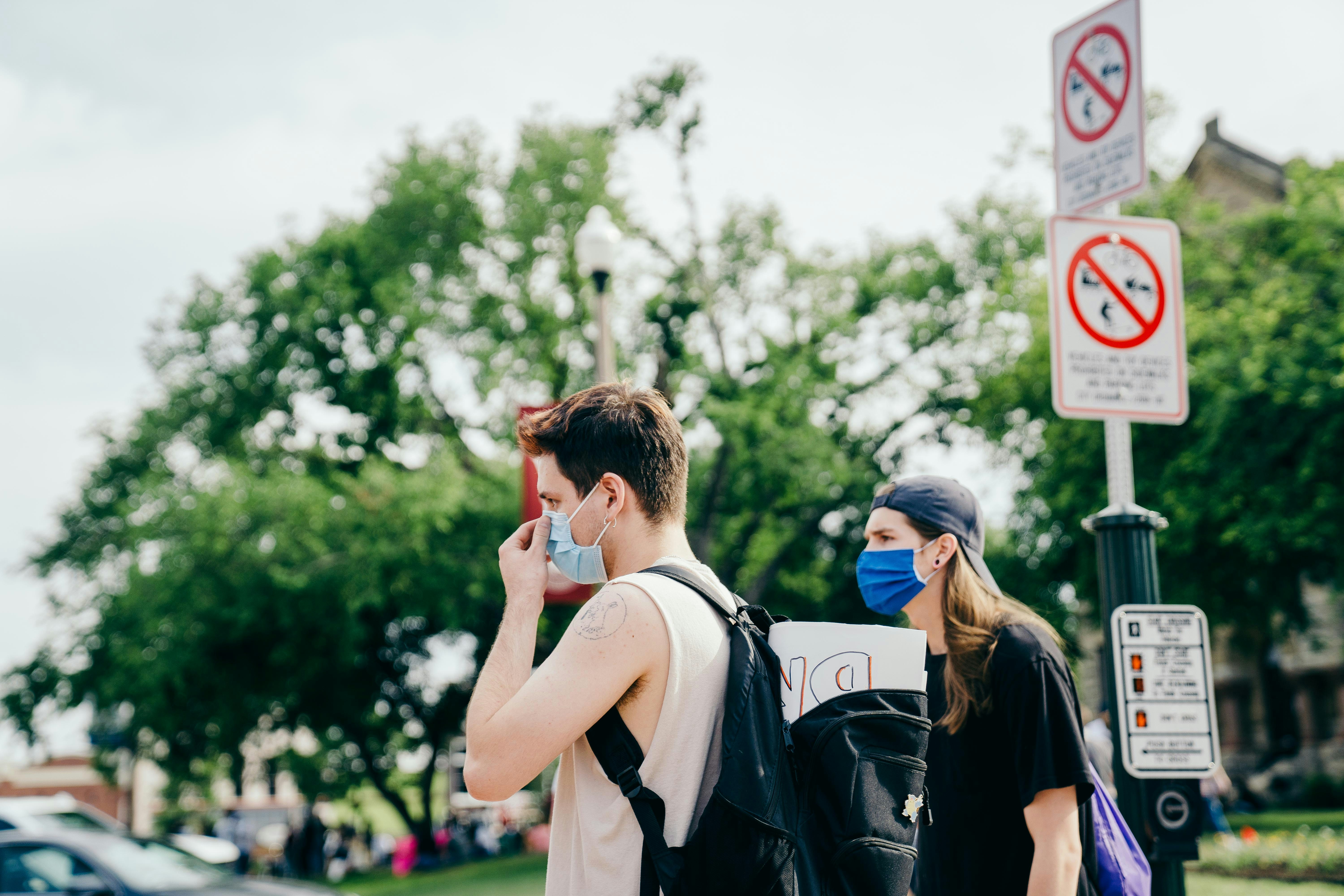 woman in white tank top standing beside man in black shirt
