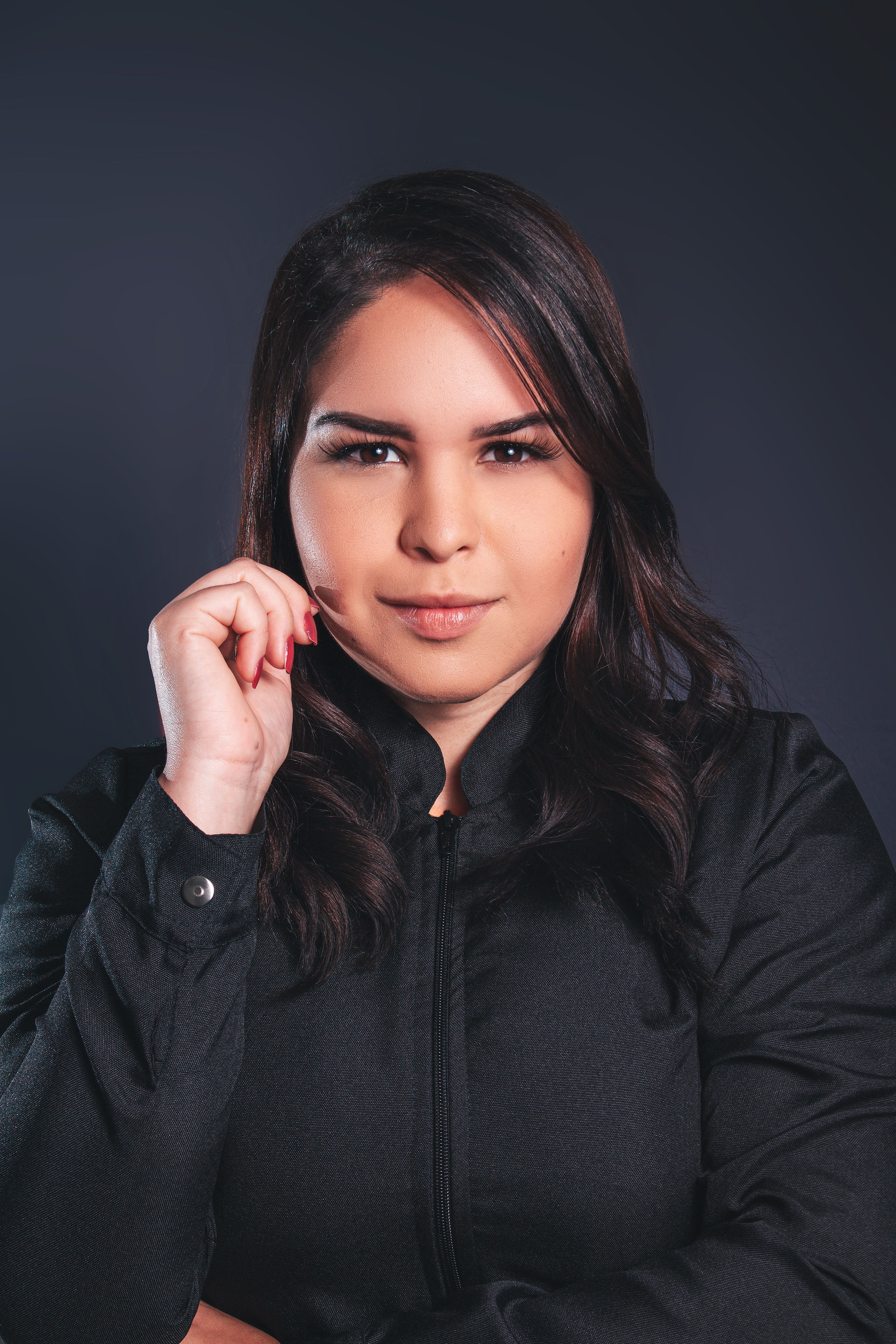 Woman head shot wearing a black shirt with a sleek look