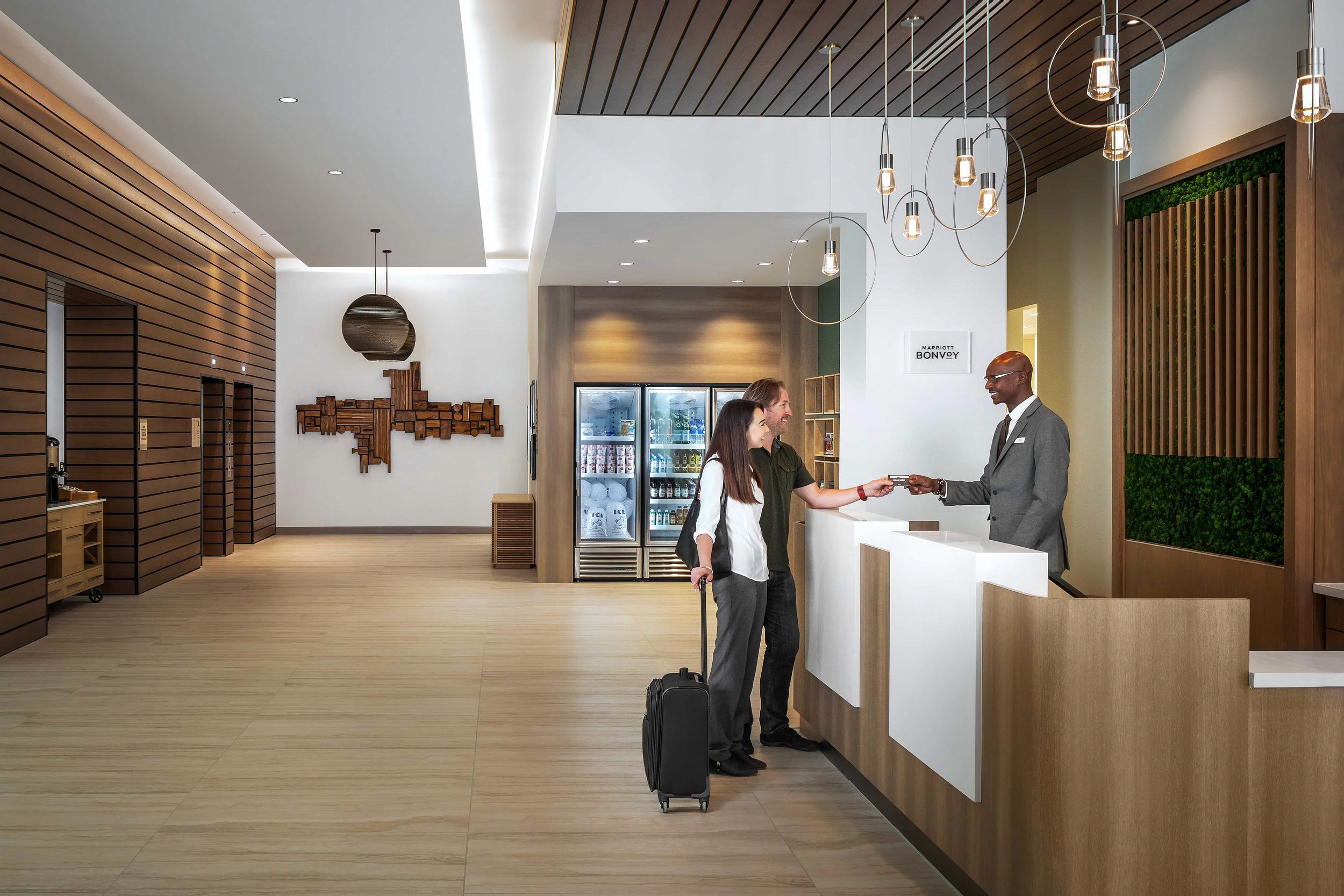 Couple checking in at hotel front desk