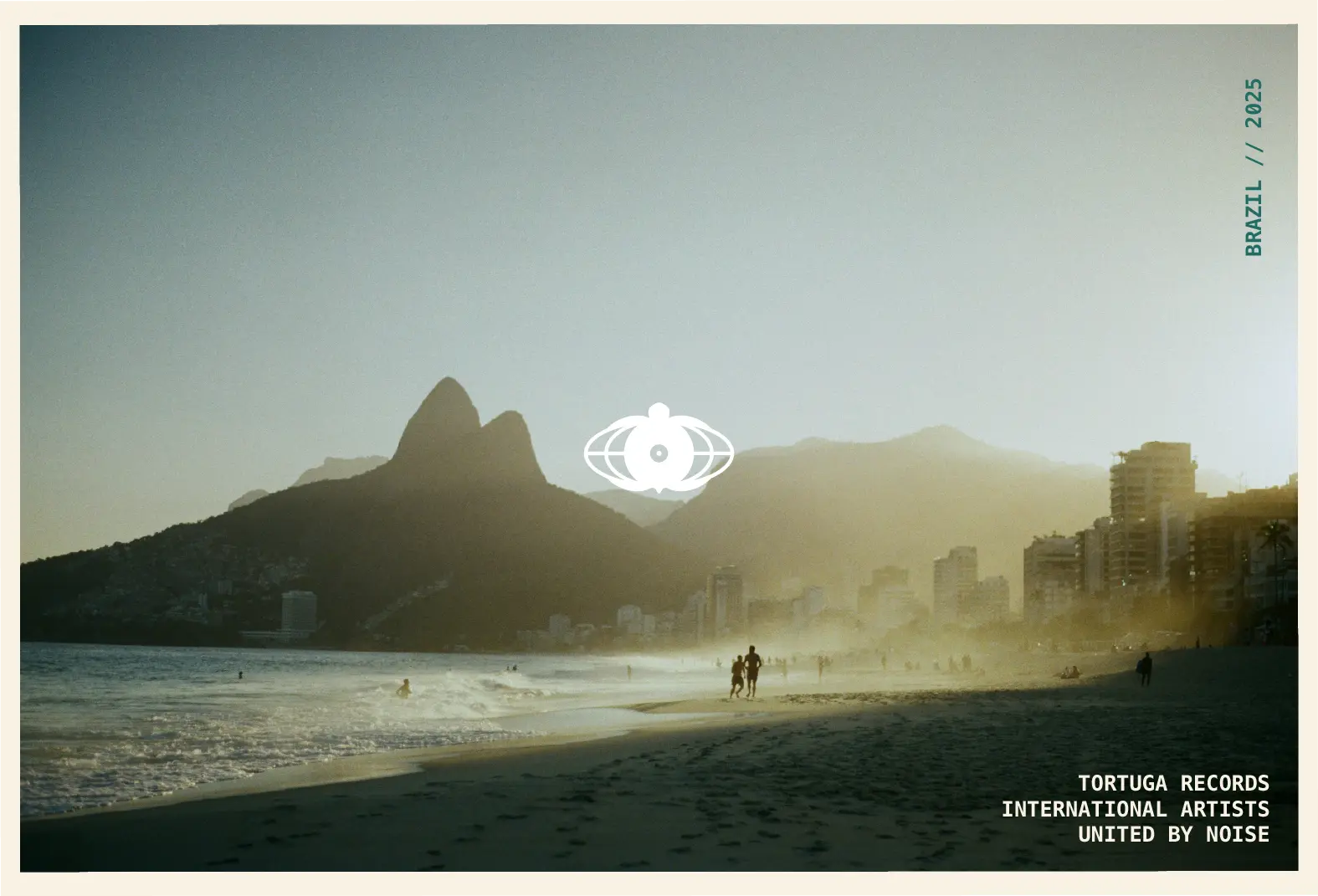 Postcard featuring the Tortuga turtle globe logo over a misty beach scene in Rio de Janeiro with mountains in the background.