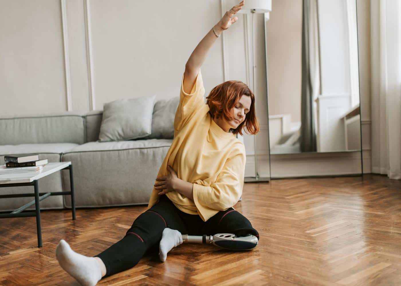Adaptive fitness at home - woman stretching on the floor