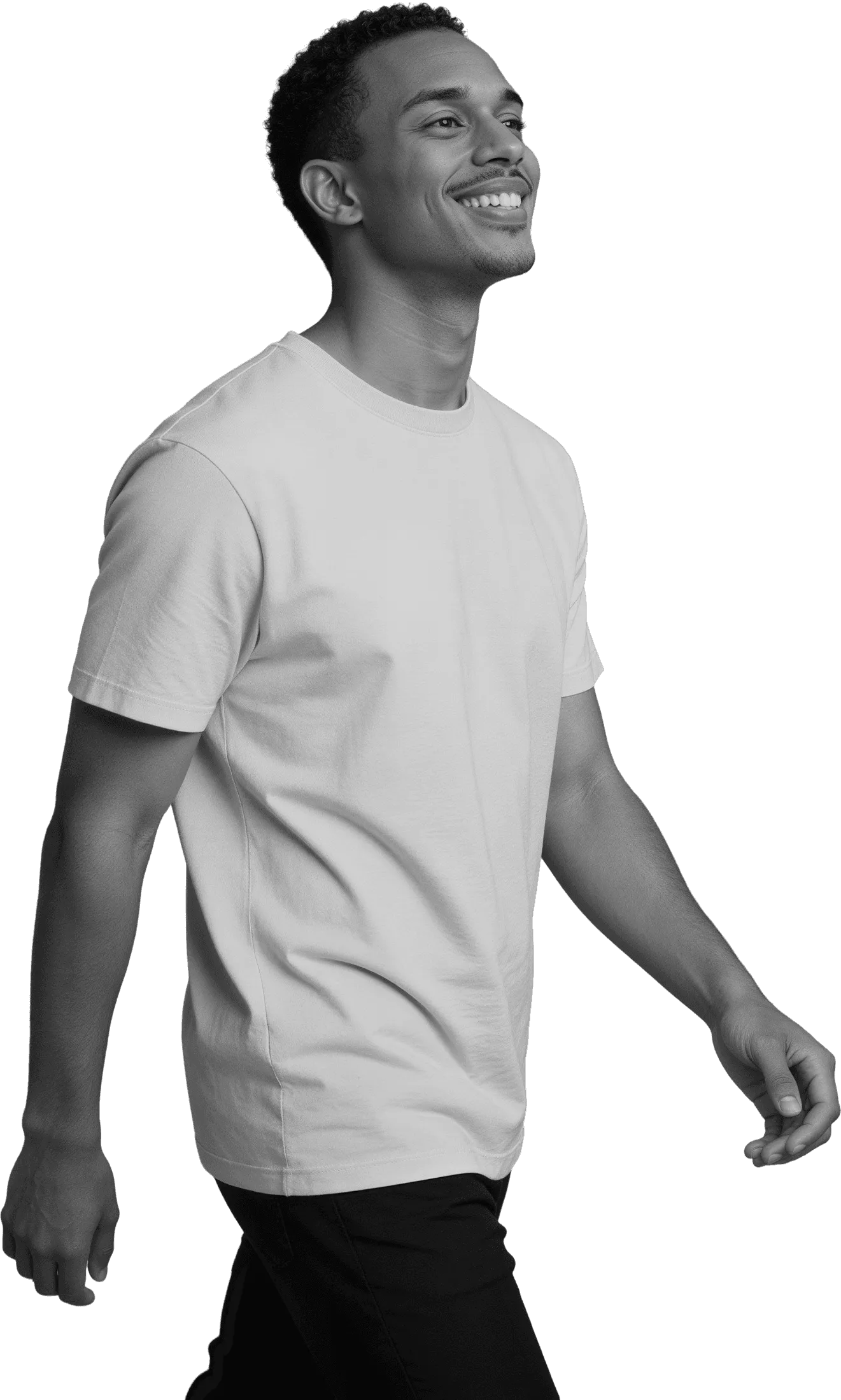 Side profile of a joyful man walking and looking up with a big smile, captured in high-contrast monochrome