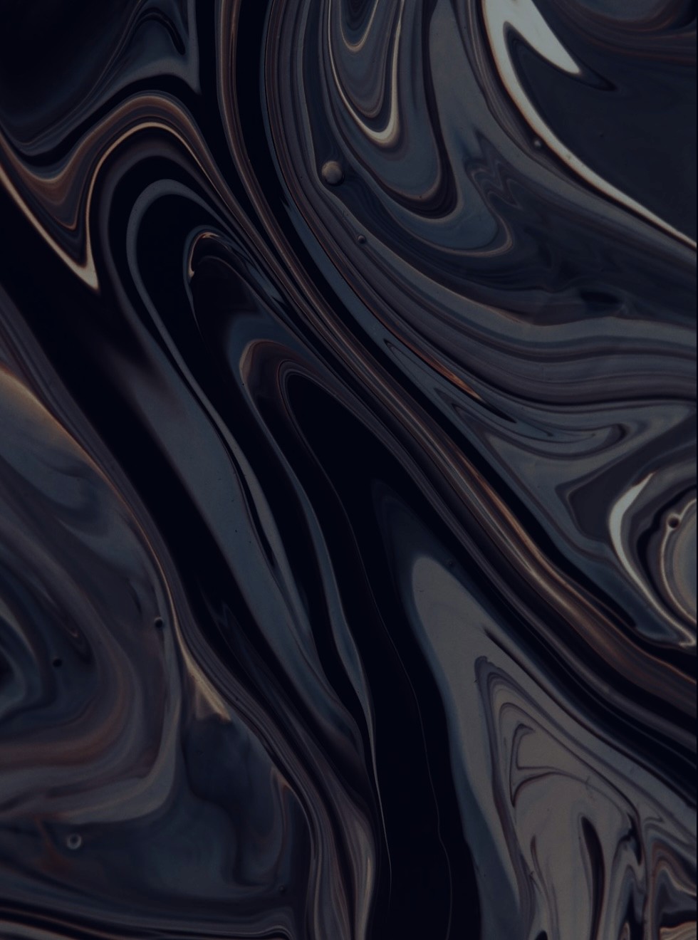 Warm dining nook with brown walls, modern pendant light, round table, green chairs, and dried pampas grass.