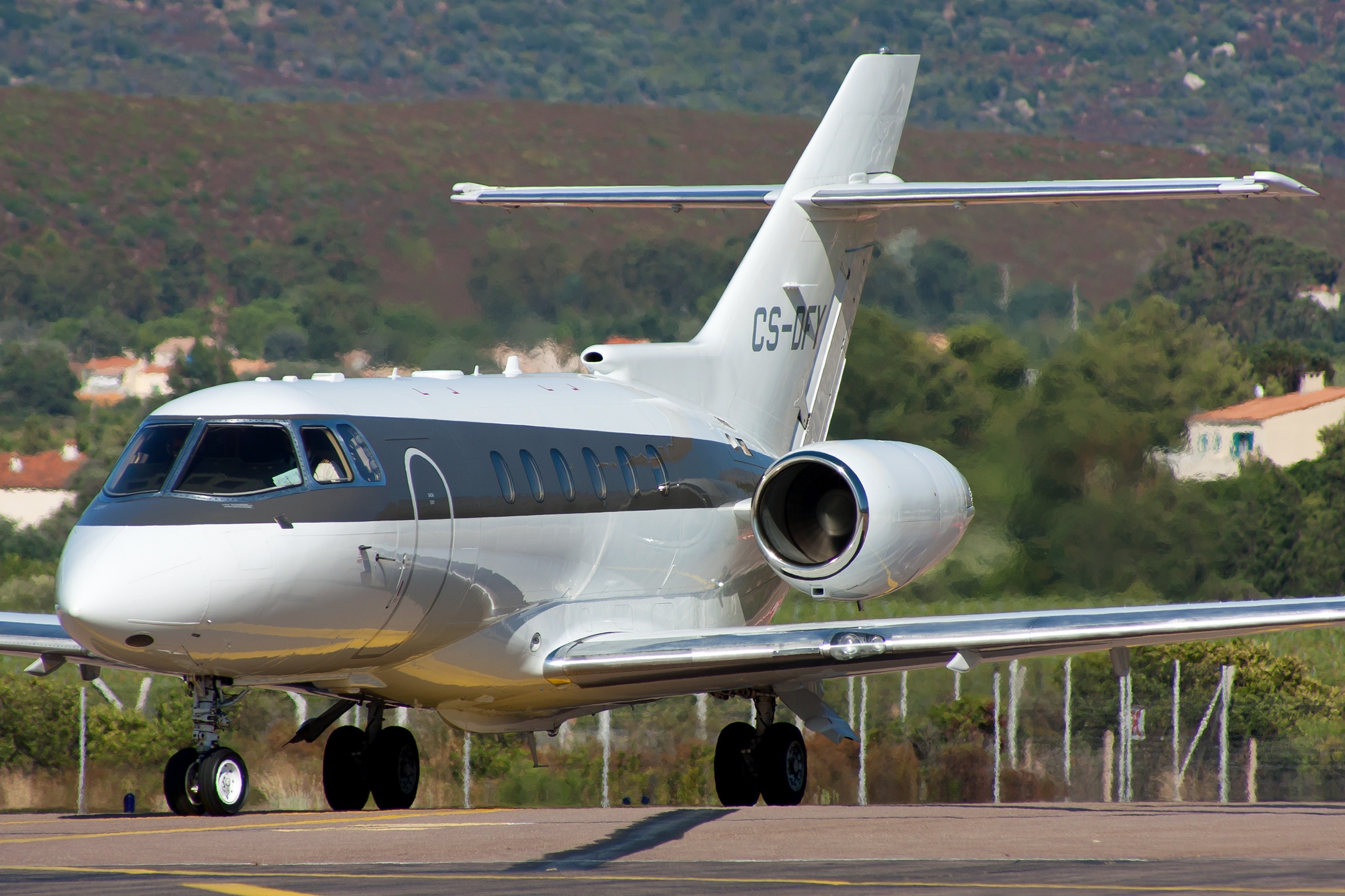 white airliner on gray pavement