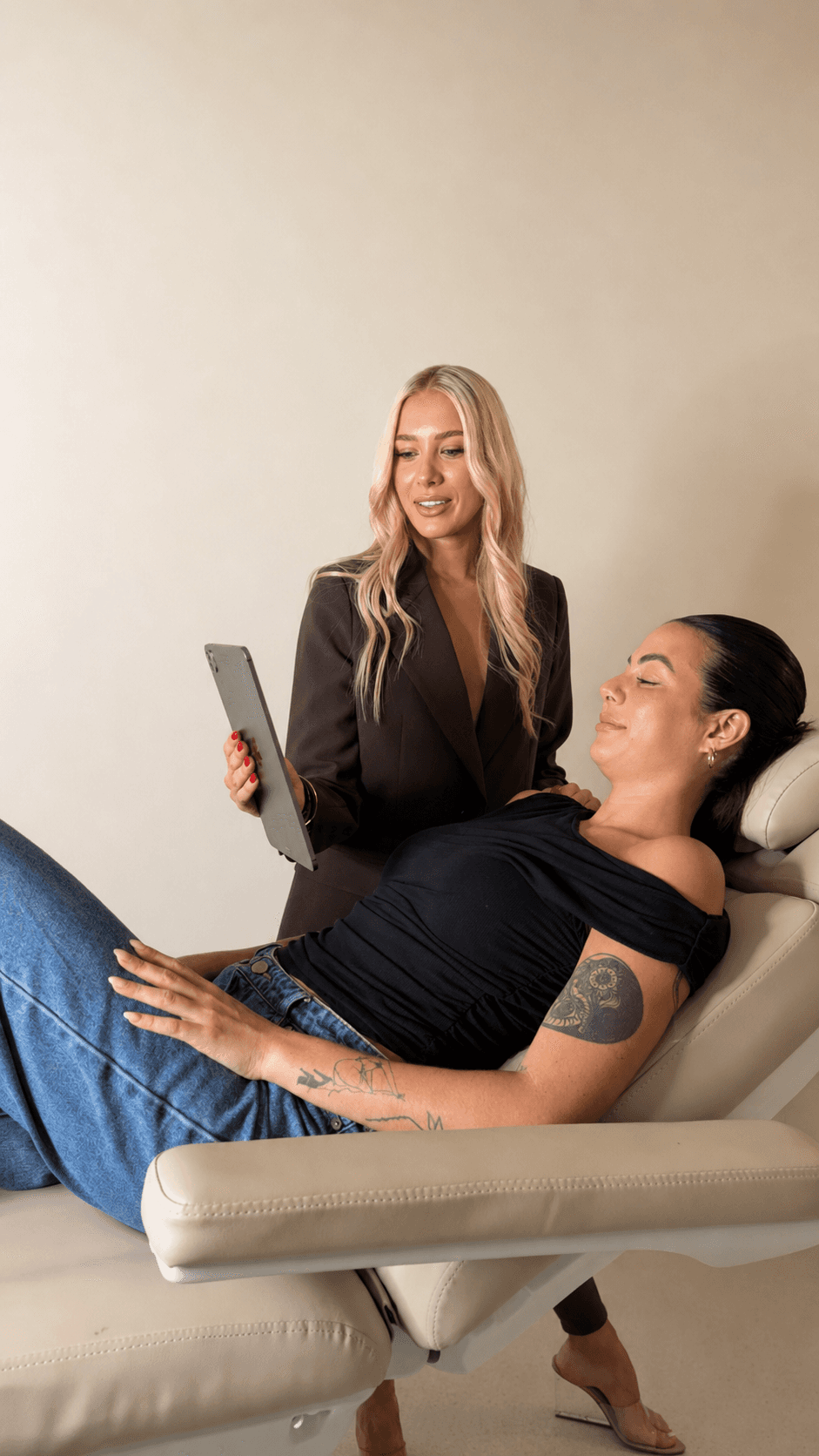 Practitioner showing a client her treatment plan on a tablet