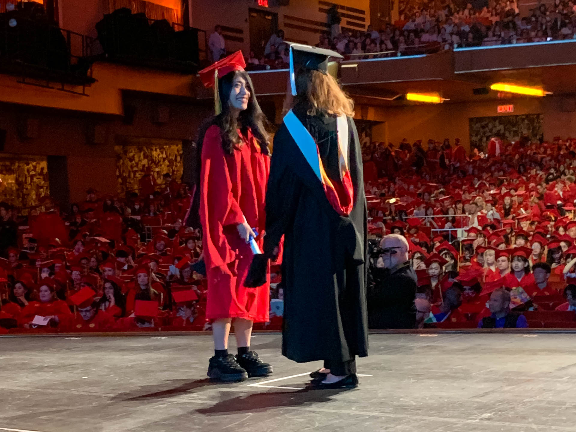 a student getting their diploma on stage
