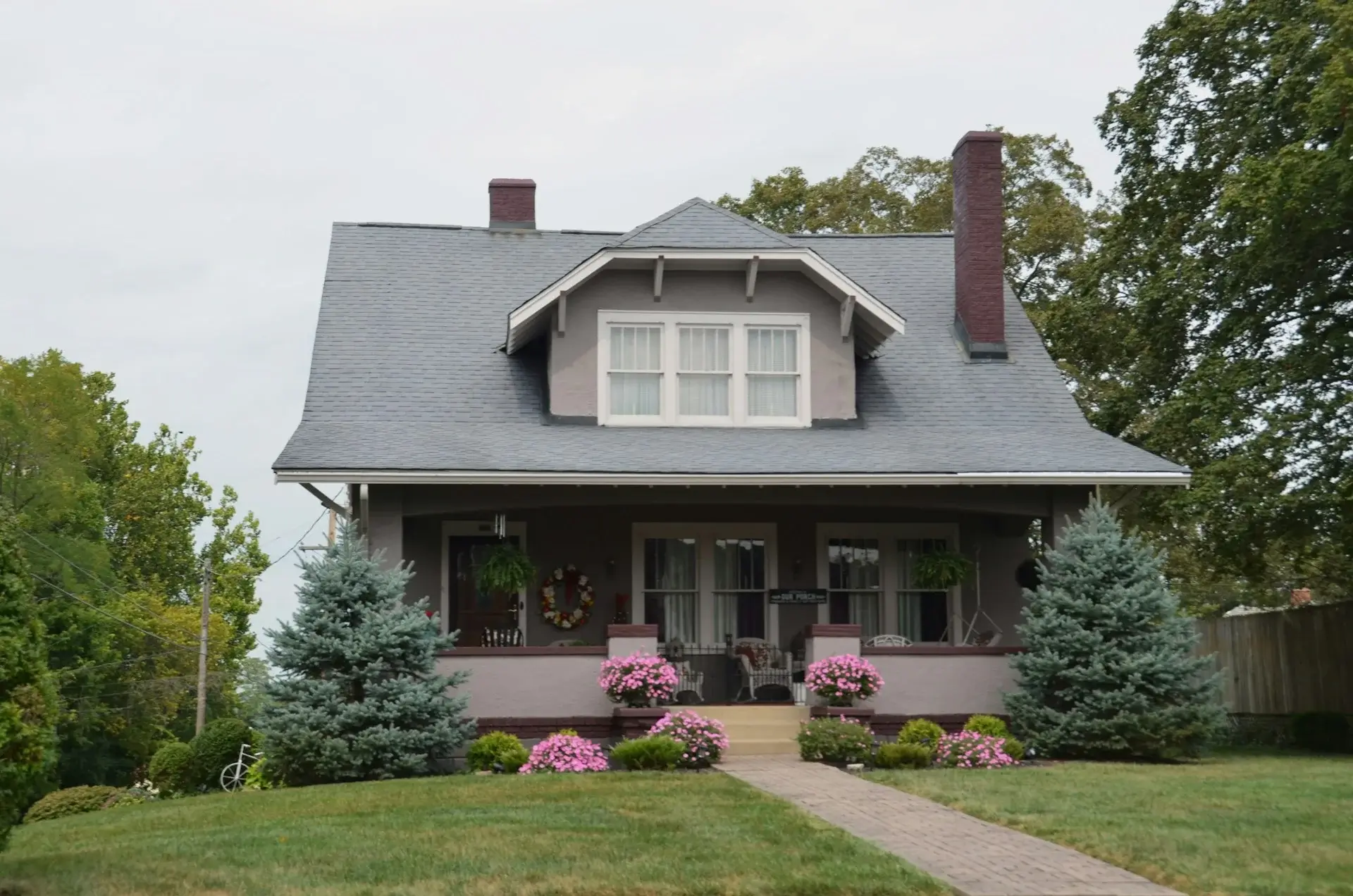 Gray cottage-style house with front porch.