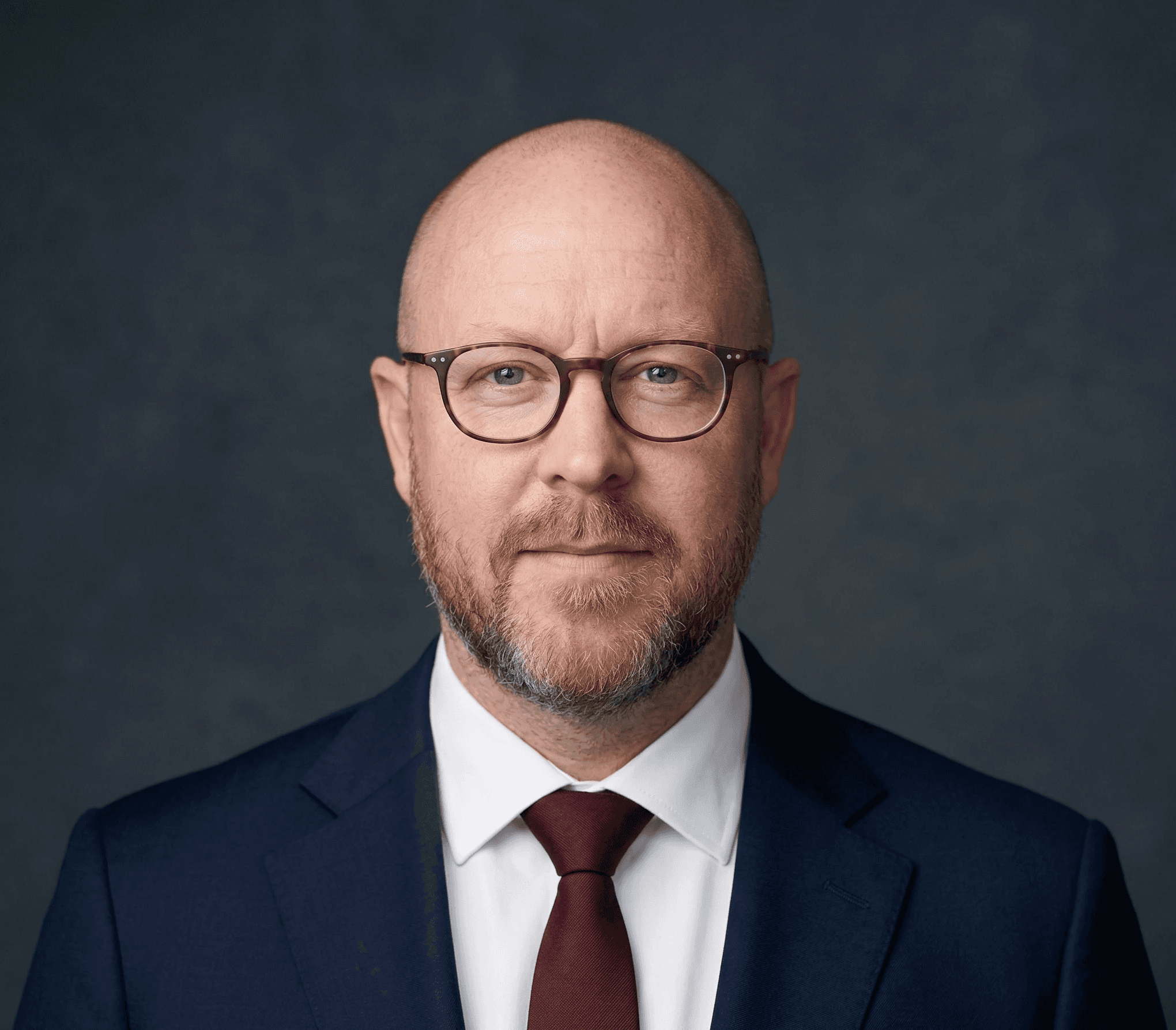 a man with a dark suit and tie