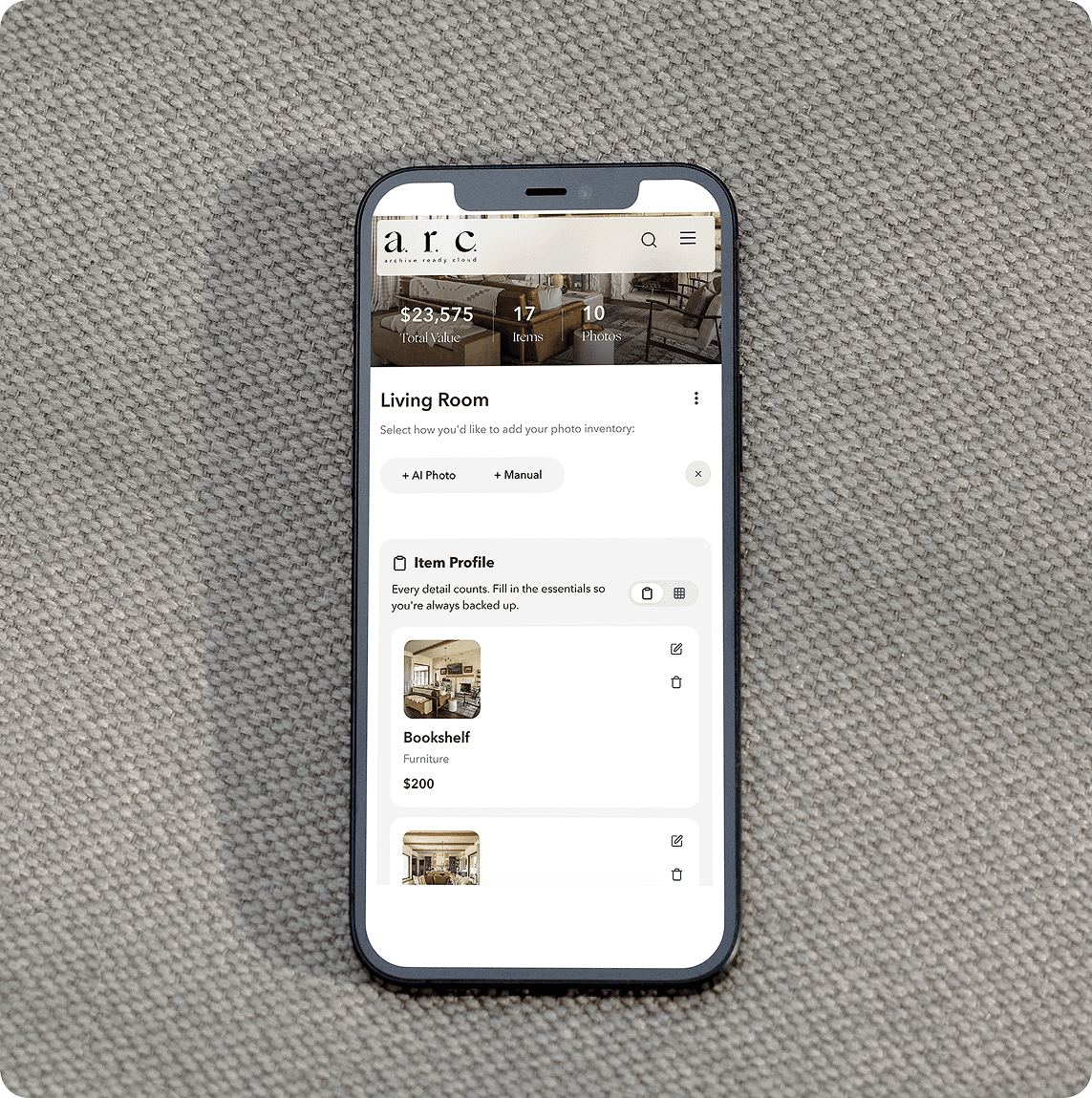 Rustic hill country living room with limestone walls, modern chandelier, gray sectional sofa, and western artwork