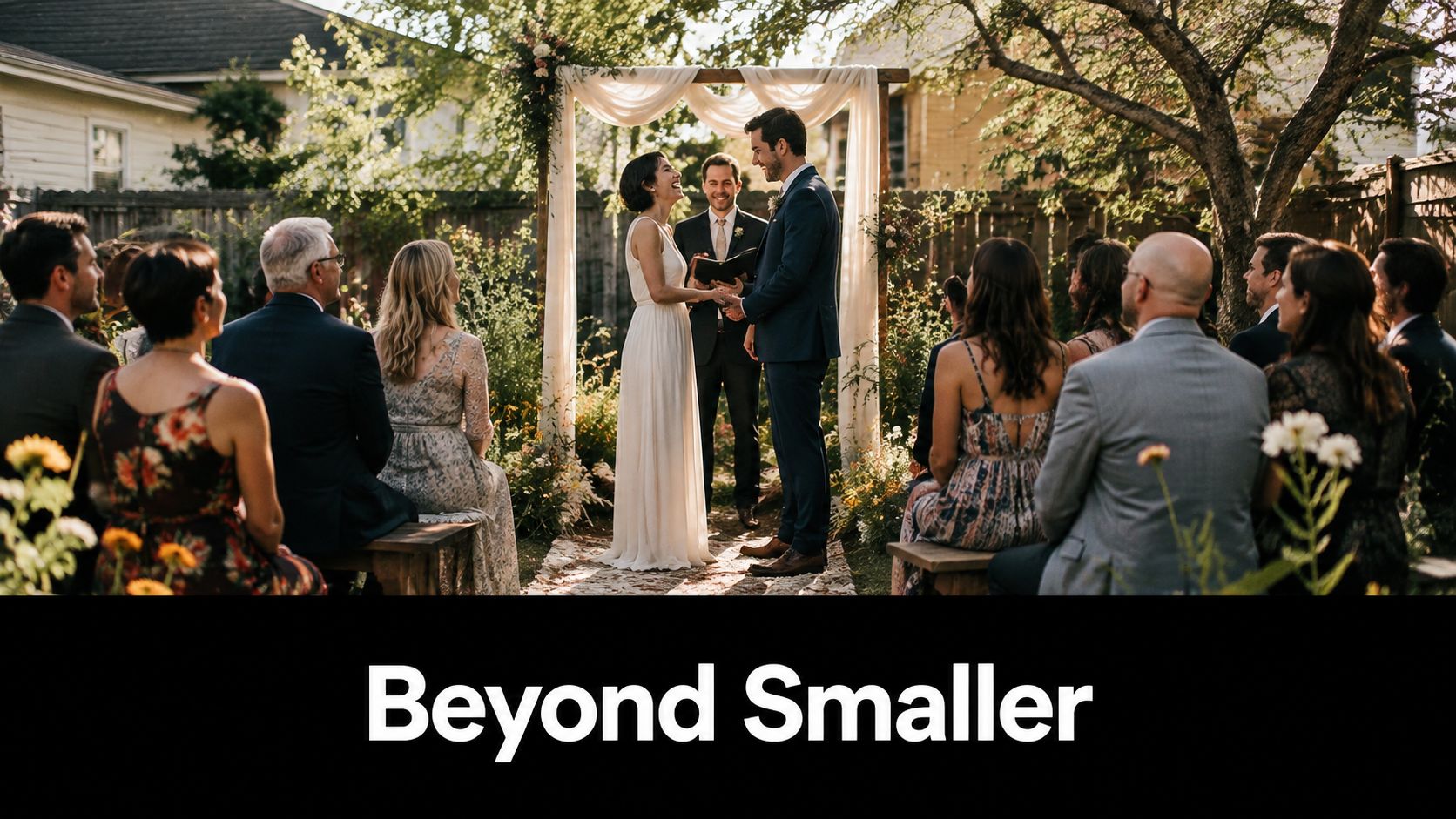 A bride and groom laughing together during an intimate outdoor wedding ceremony with guests seated behind them.