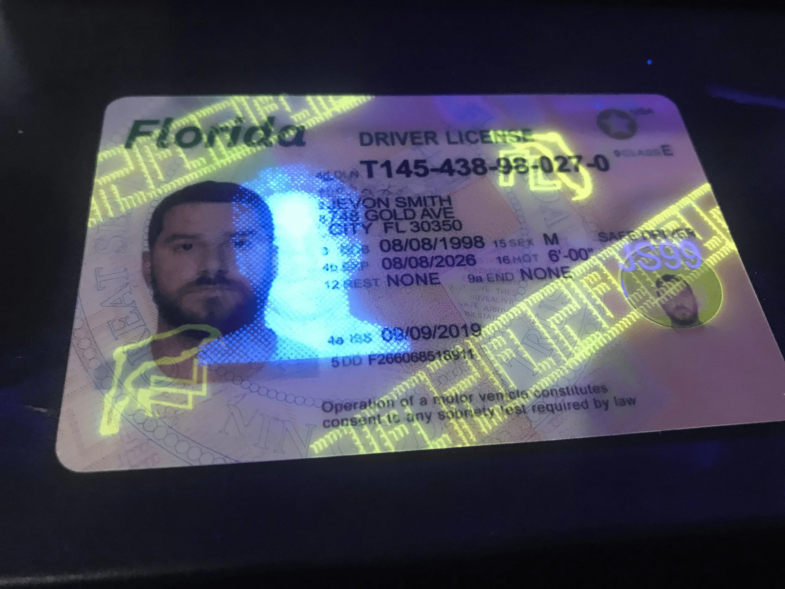 Holograms on a fake id under blacklight